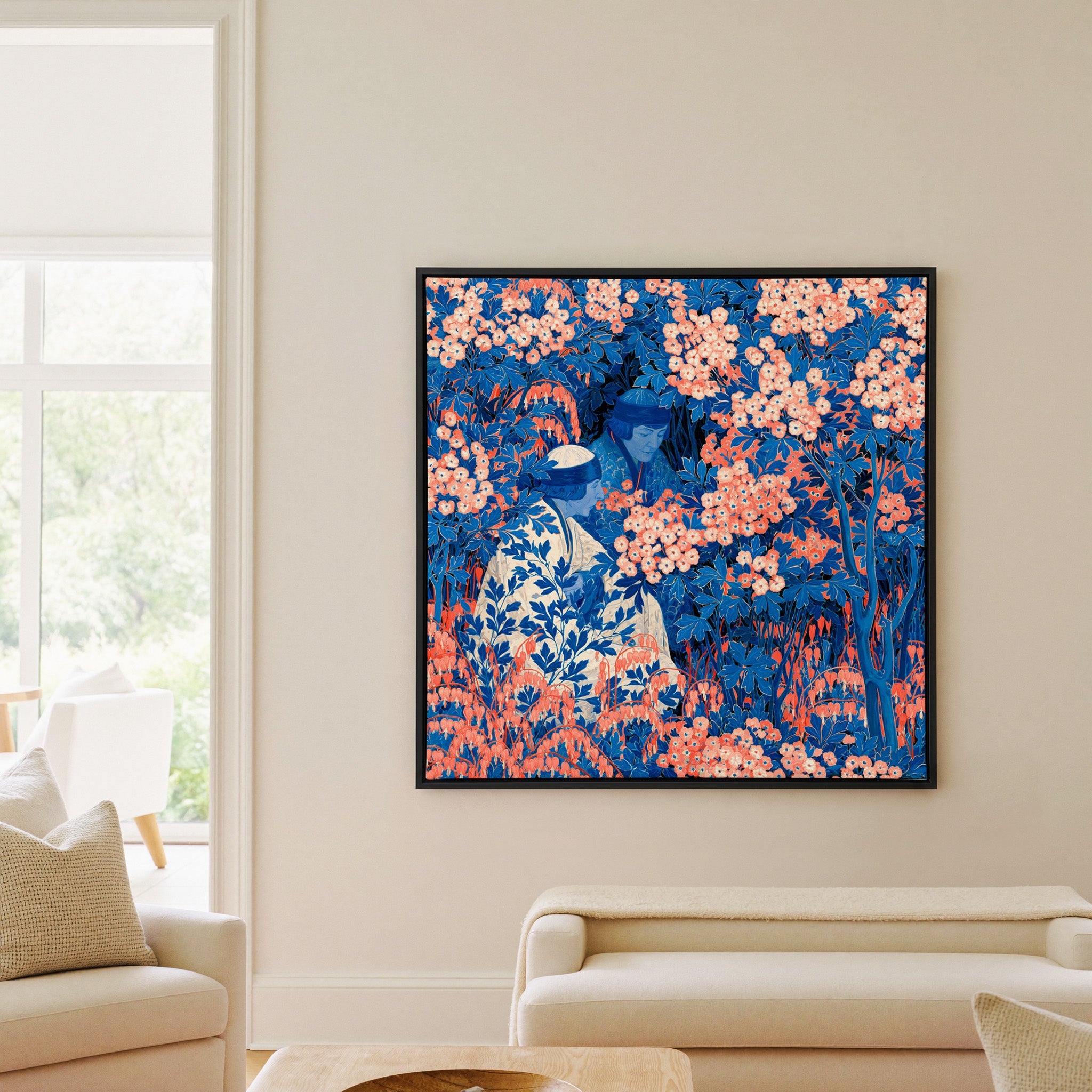 blue and coral garden scene with two seated canvas wall art in a black frame in a living room