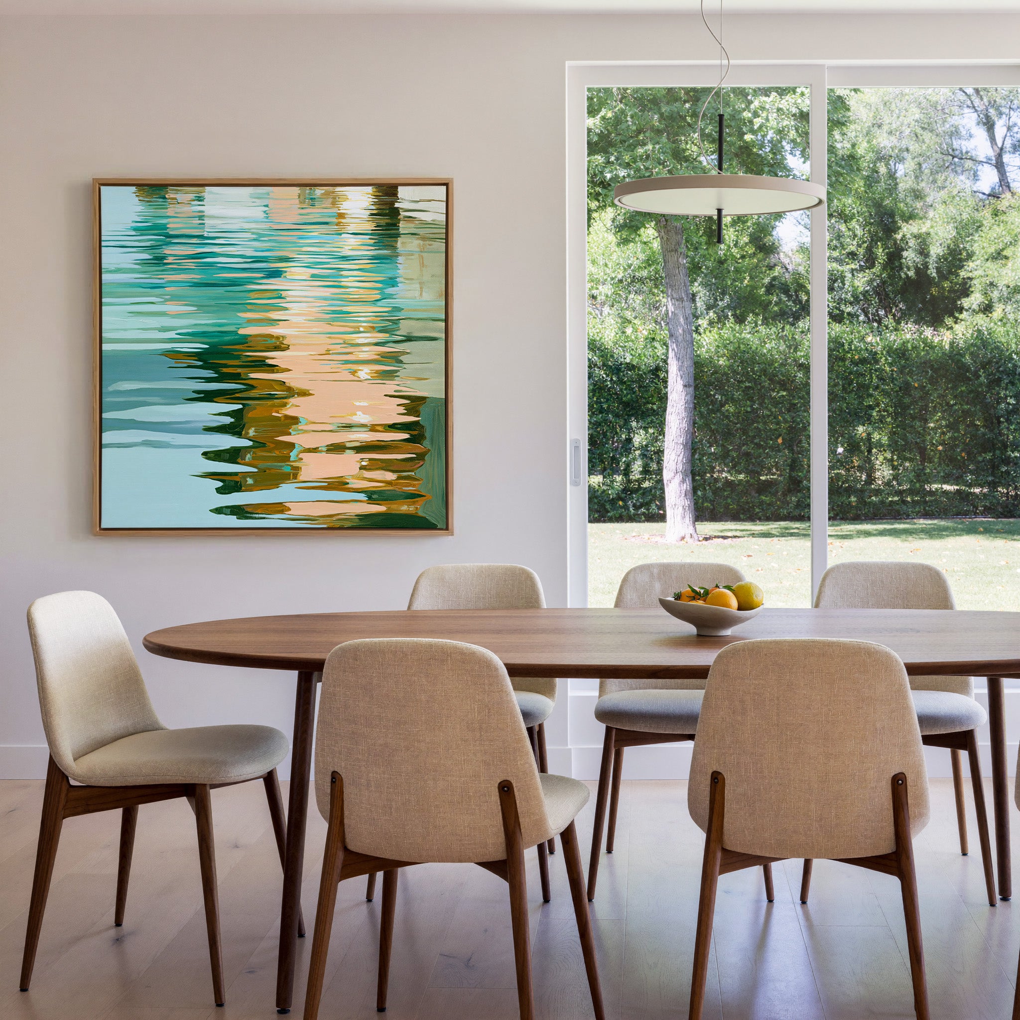 turquoise, peach, and olive abstract with canvas wall art in an oak frame in a dining room