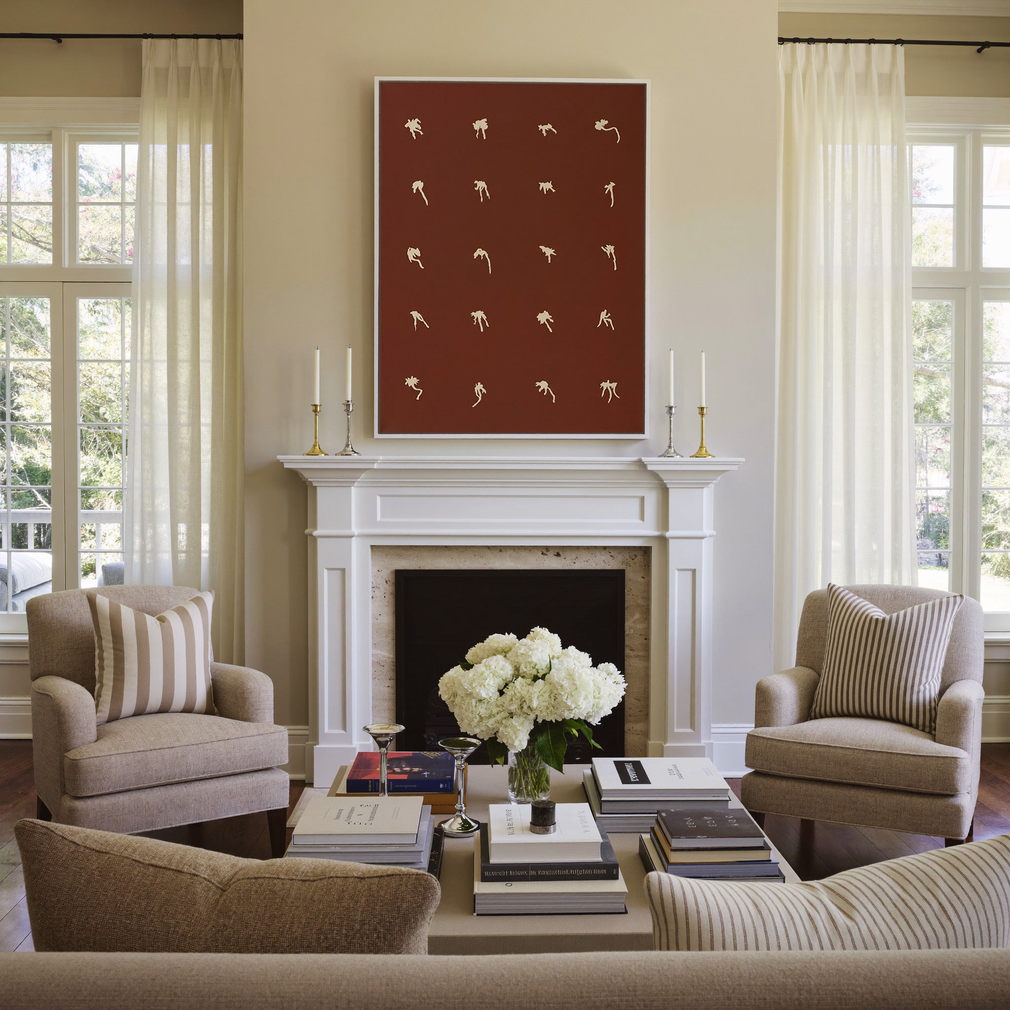 cream floral forms on a deep cocoa ground canvas wall art in a white frame above a mantel