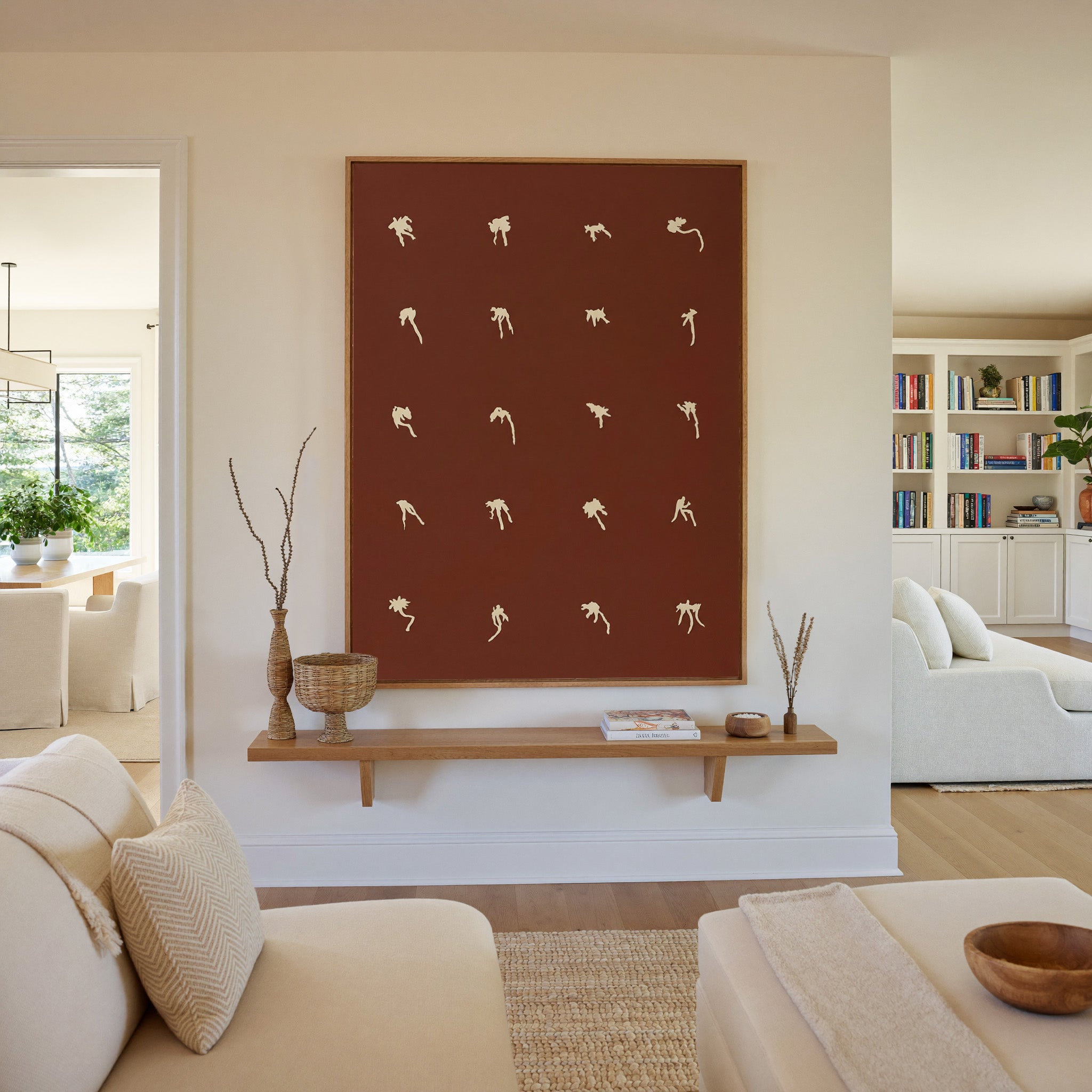 cream floral forms on a deep cocoa ground canvas wall art in an oak frame in a living room