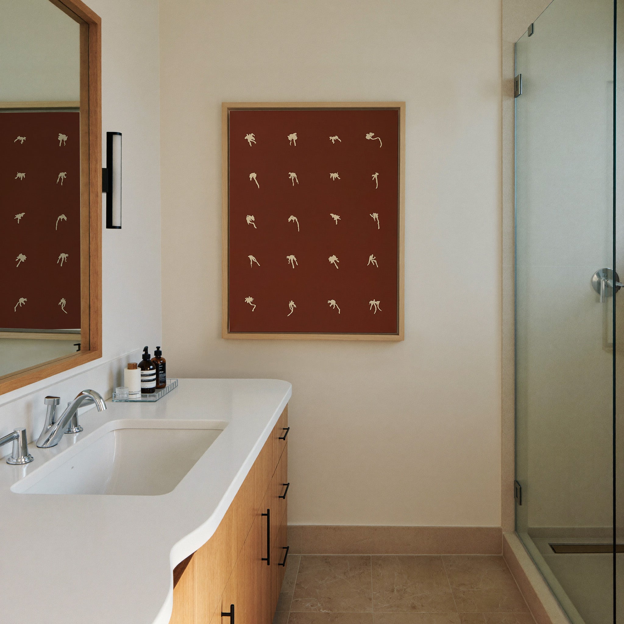 cream floral forms on a deep cocoa ground canvas wall art in a natural wood frame in a styled room setting