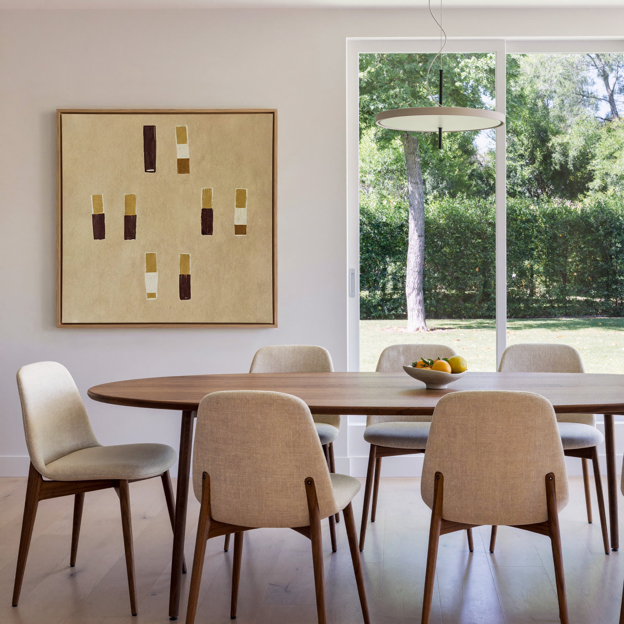 beige abstract with burgundy and ochre blocks canvas wall art in an oak frame in a dining room