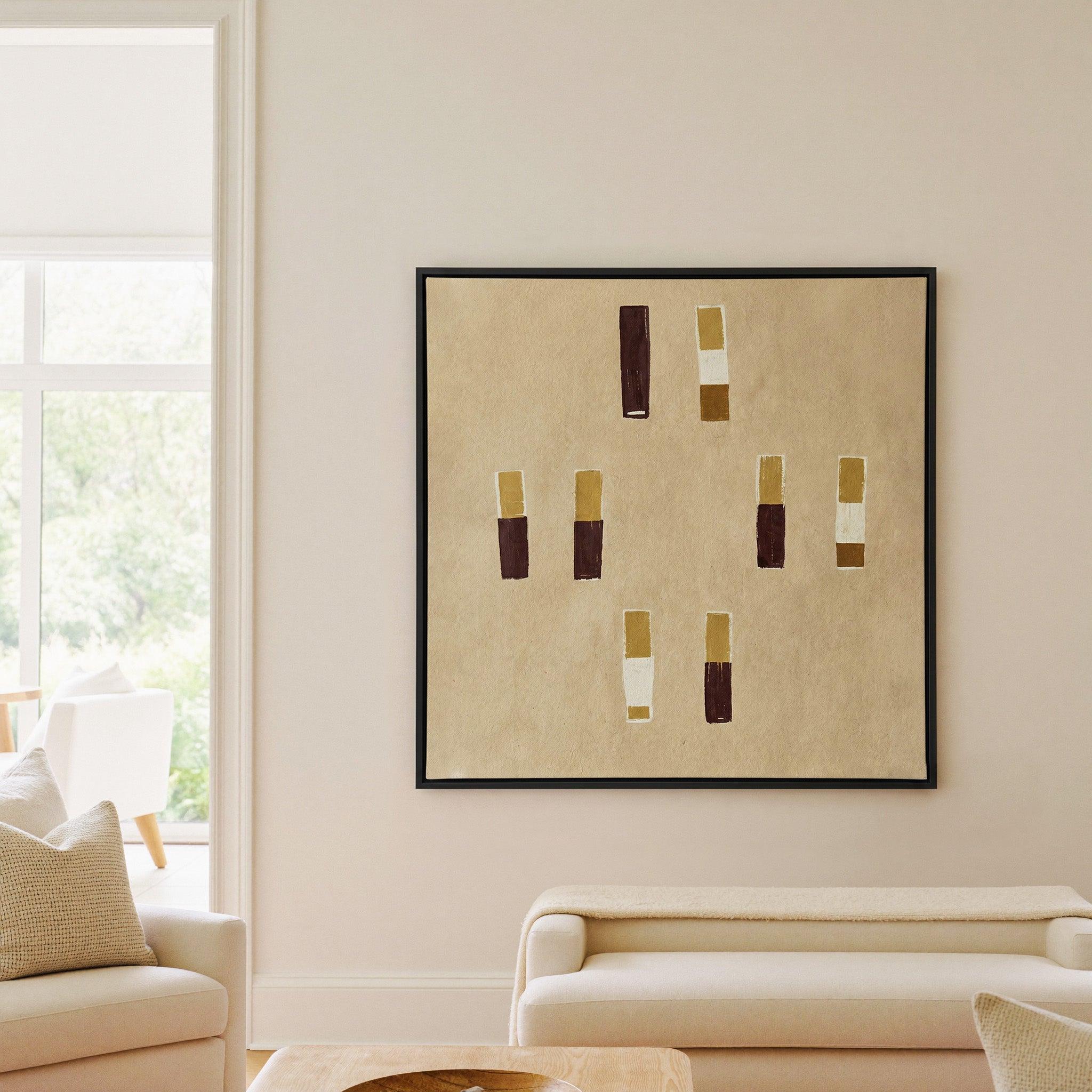beige abstract with burgundy and ochre blocks canvas wall art in a black frame in a living room