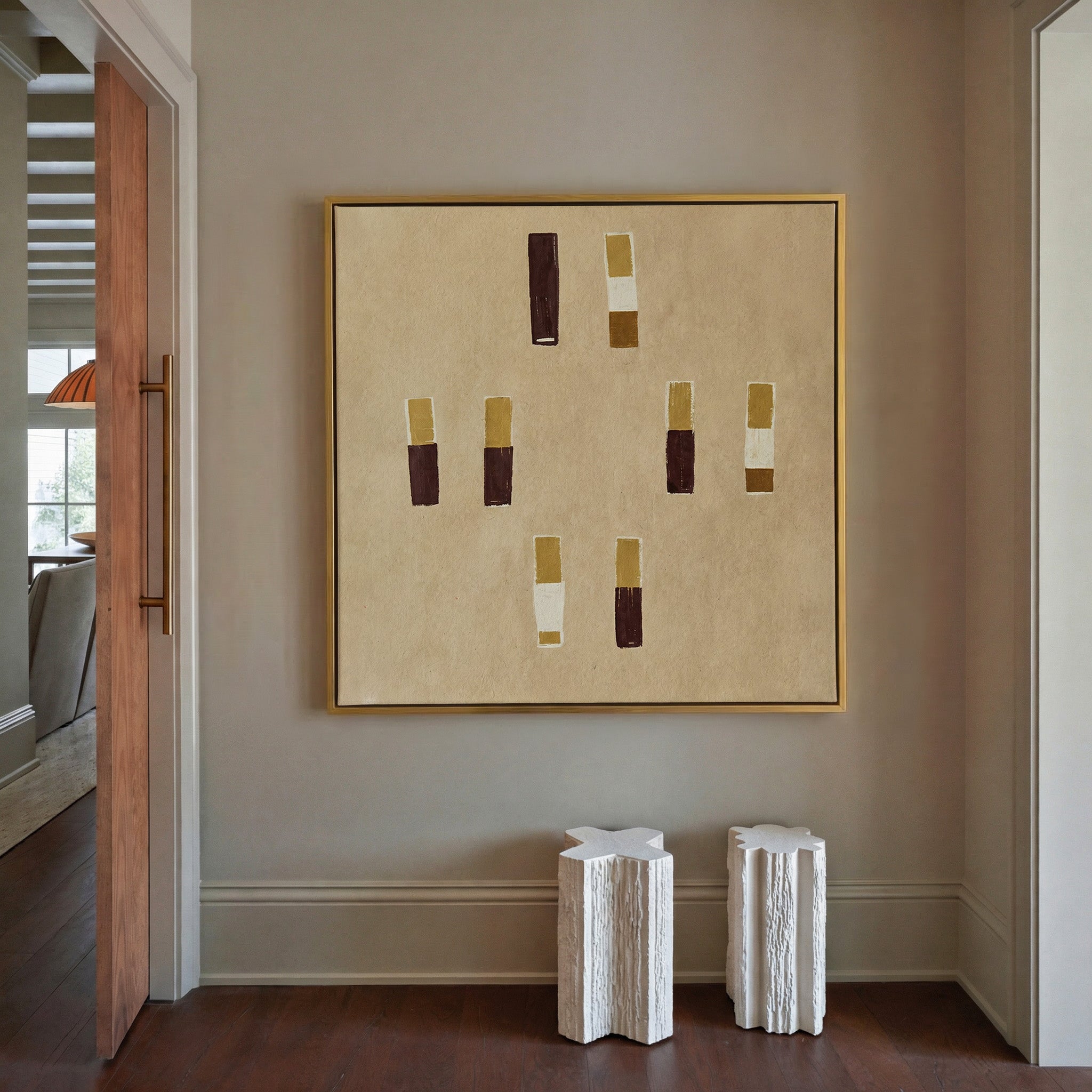 beige abstract with burgundy and ochre blocks canvas wall art in a gold frame in a styled room setting