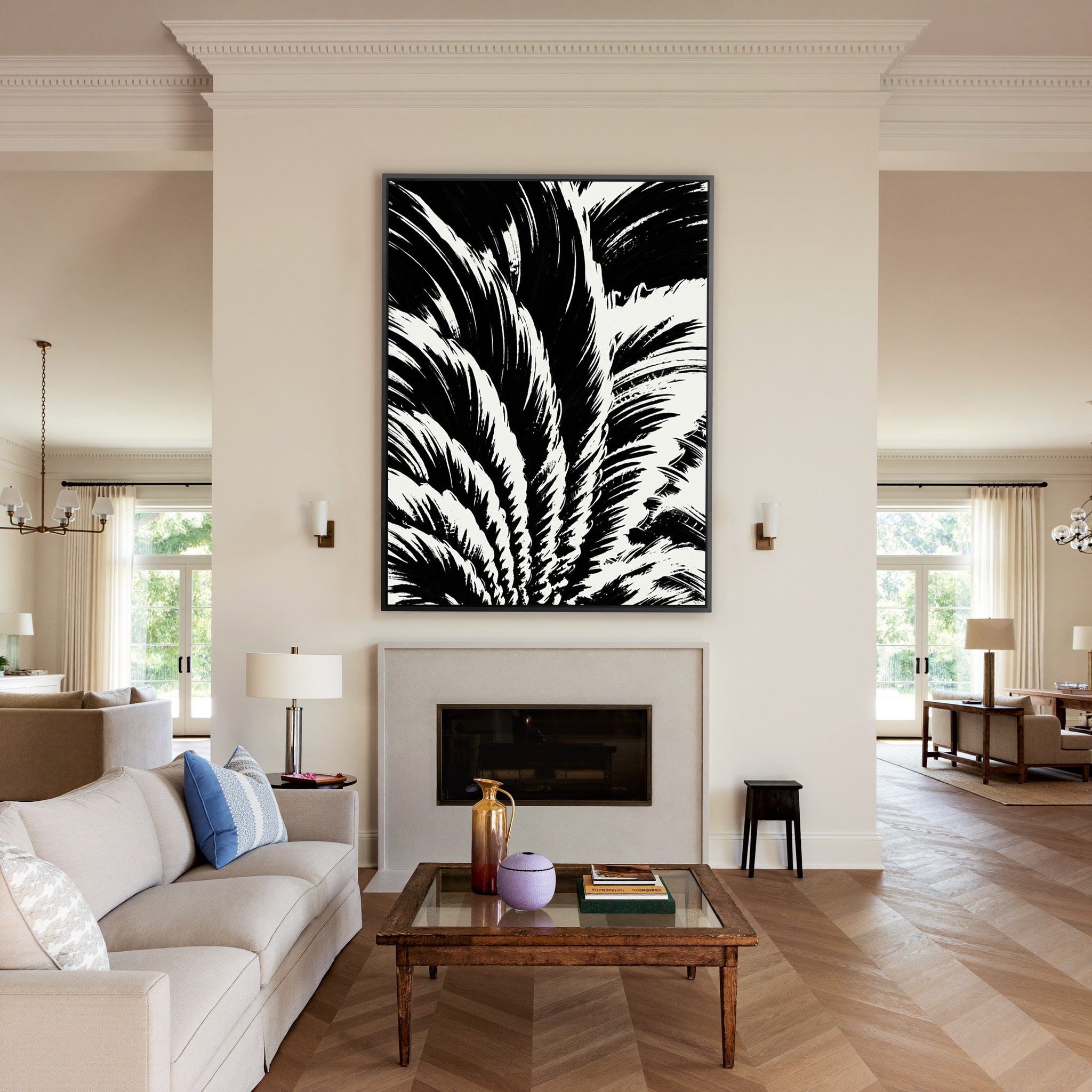 black and white palm leaf abstract canvas wall art in a black frame above a mantel