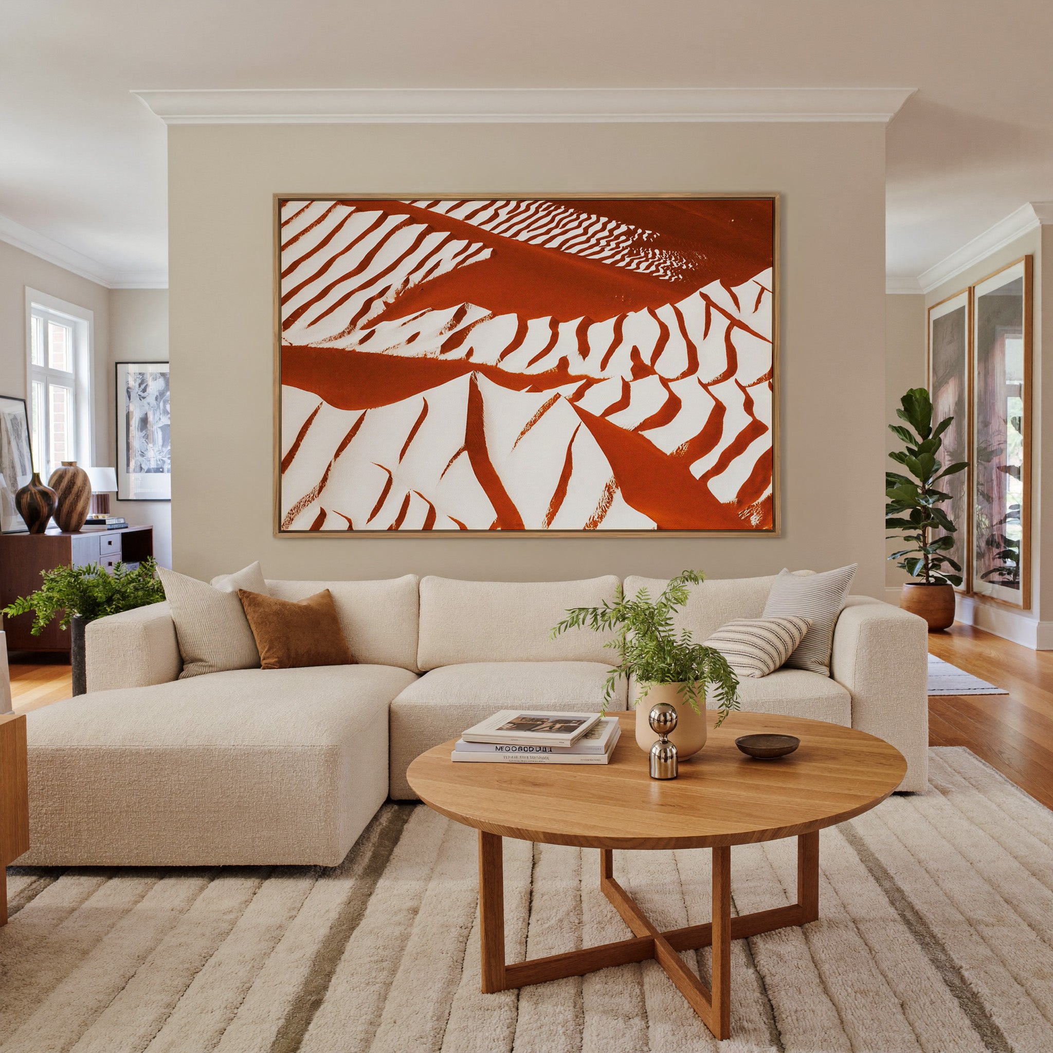 rust and cream abstract with sweeping diagonal canvas wall art in an oak frame in a living room