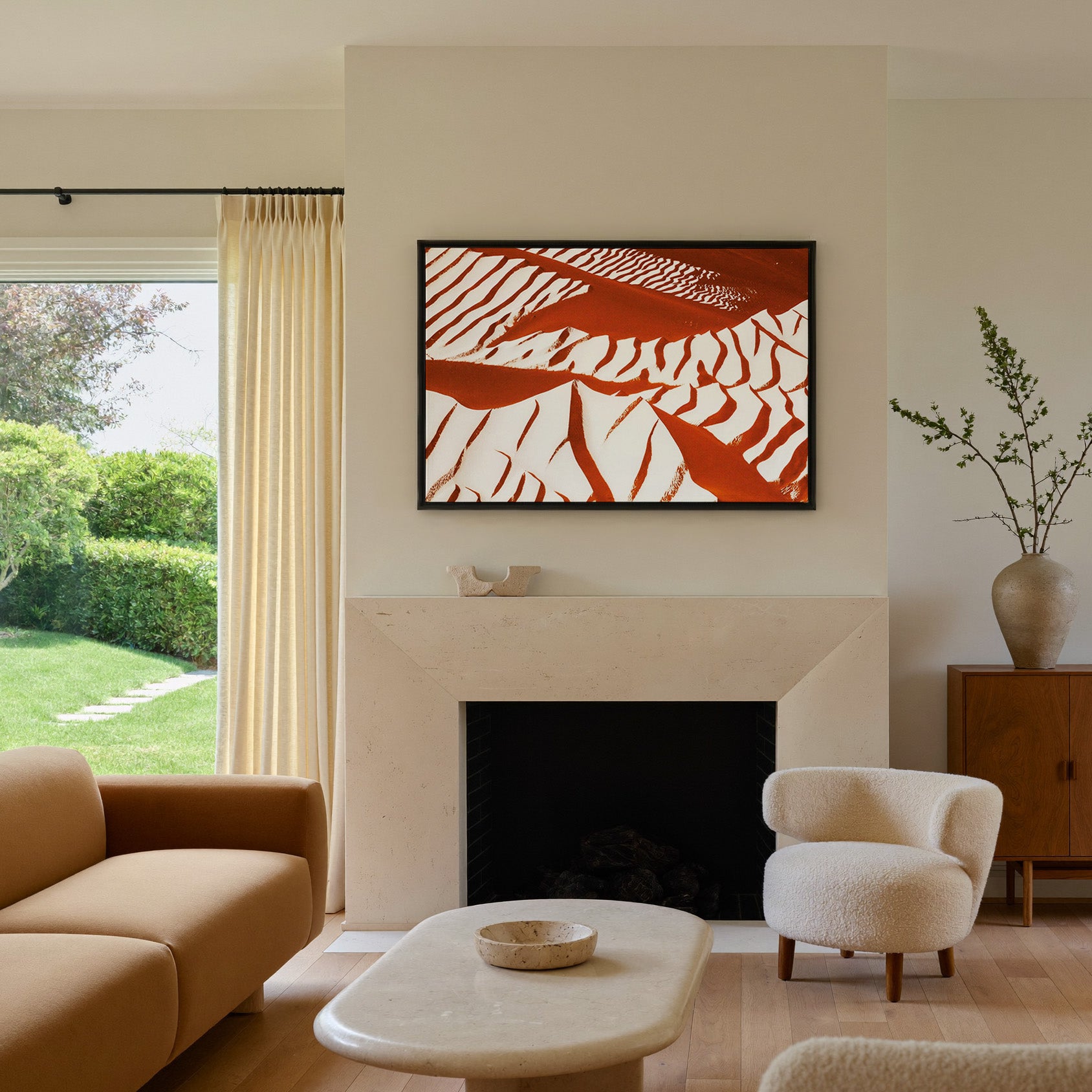 rust and cream abstract with sweeping diagonal canvas wall art in a black frame above a mantel