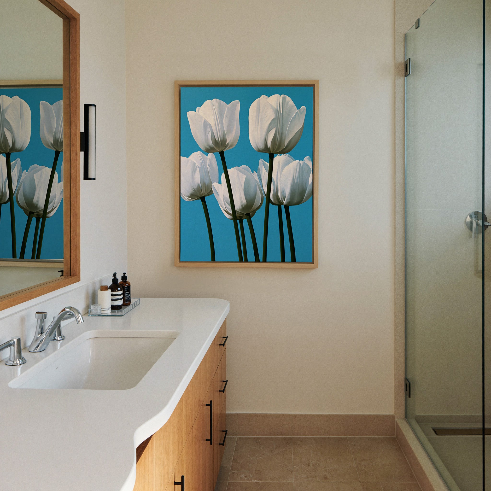 white tulips with deep green canvas wall art in a natural wood frame in a styled room setting