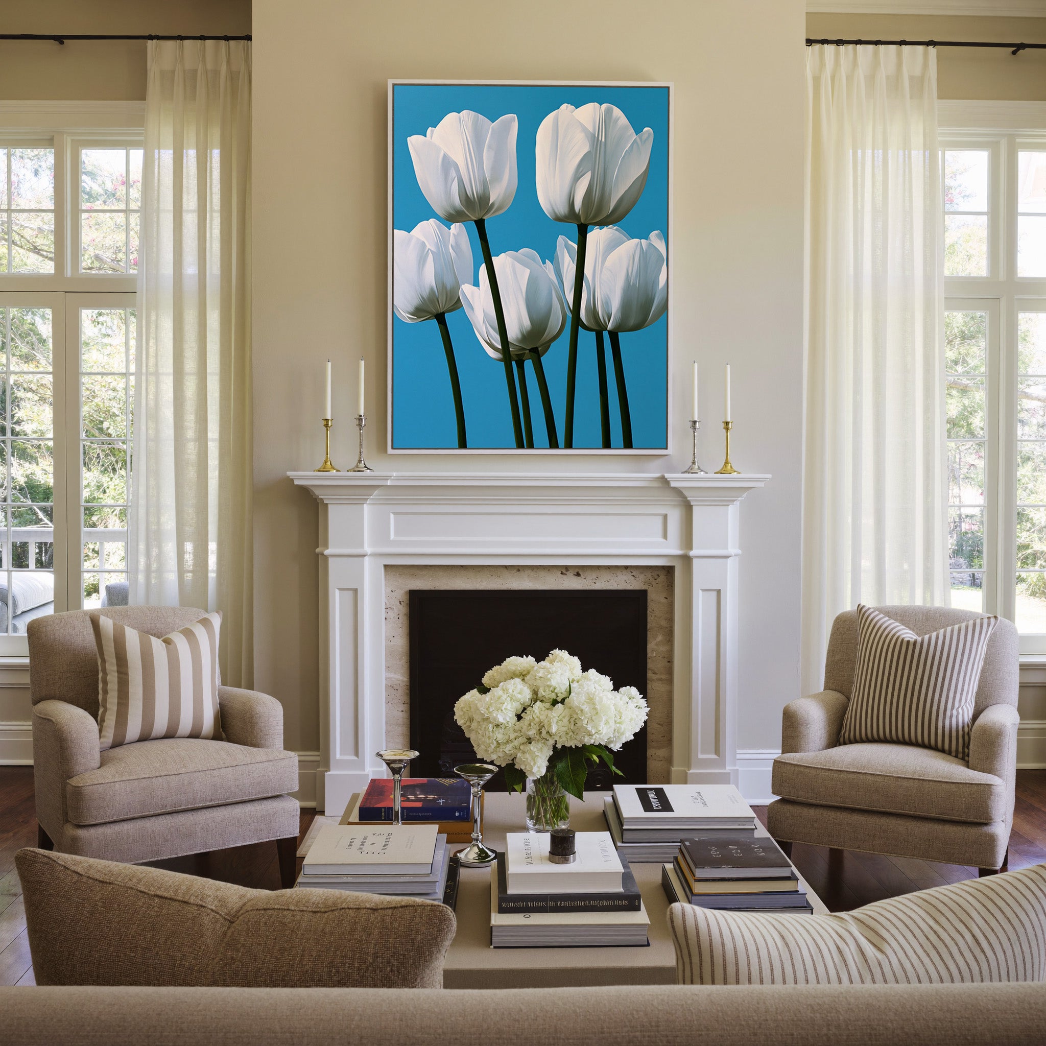 white tulips with deep green stems on a bright canvas wall art in a white frame above a mantel
