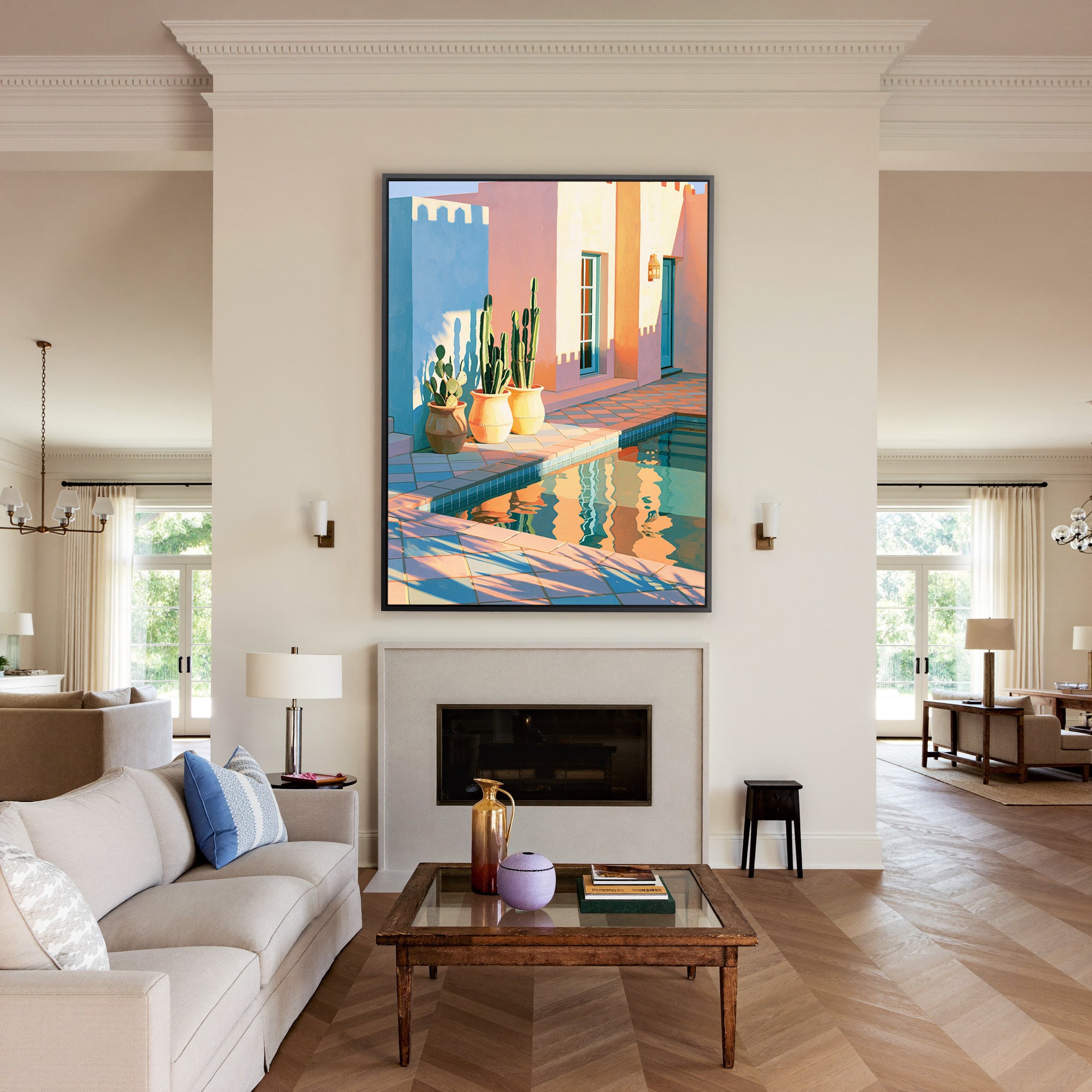 pastel courtyard with cactus pots and pool canvas wall art in a black frame above a mantel