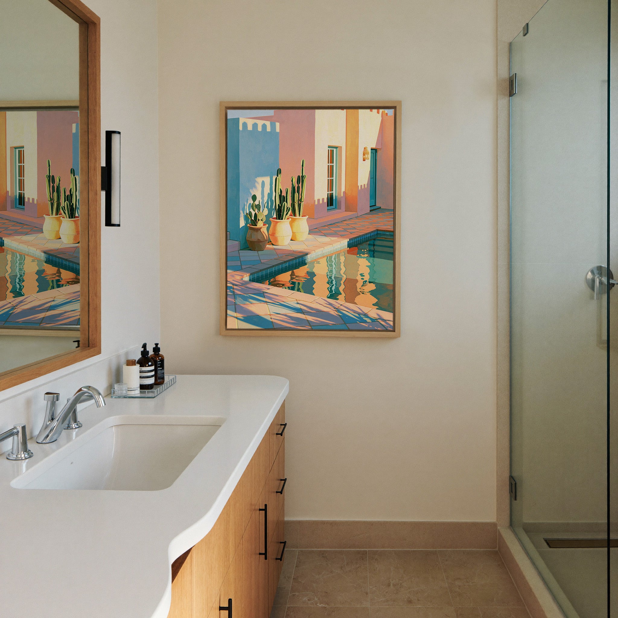 pastel courtyard with cactus pots and pool canvas wall art in a natural wood frame in a styled room setting