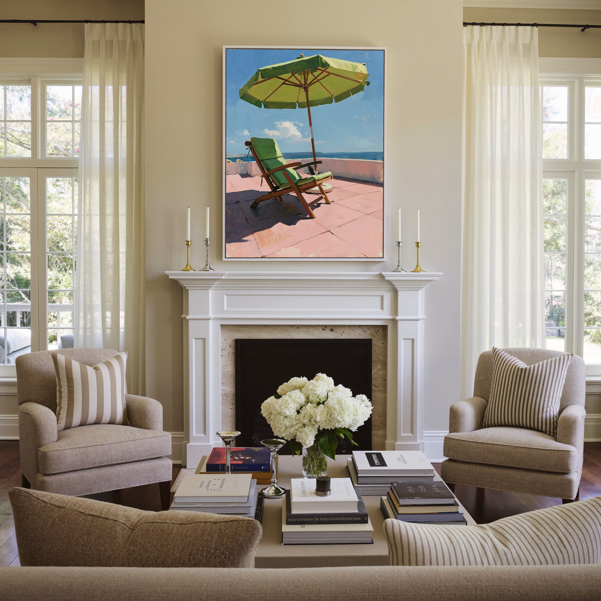 green umbrella and chair on a pink terrace canvas wall art in a white frame above a mantel