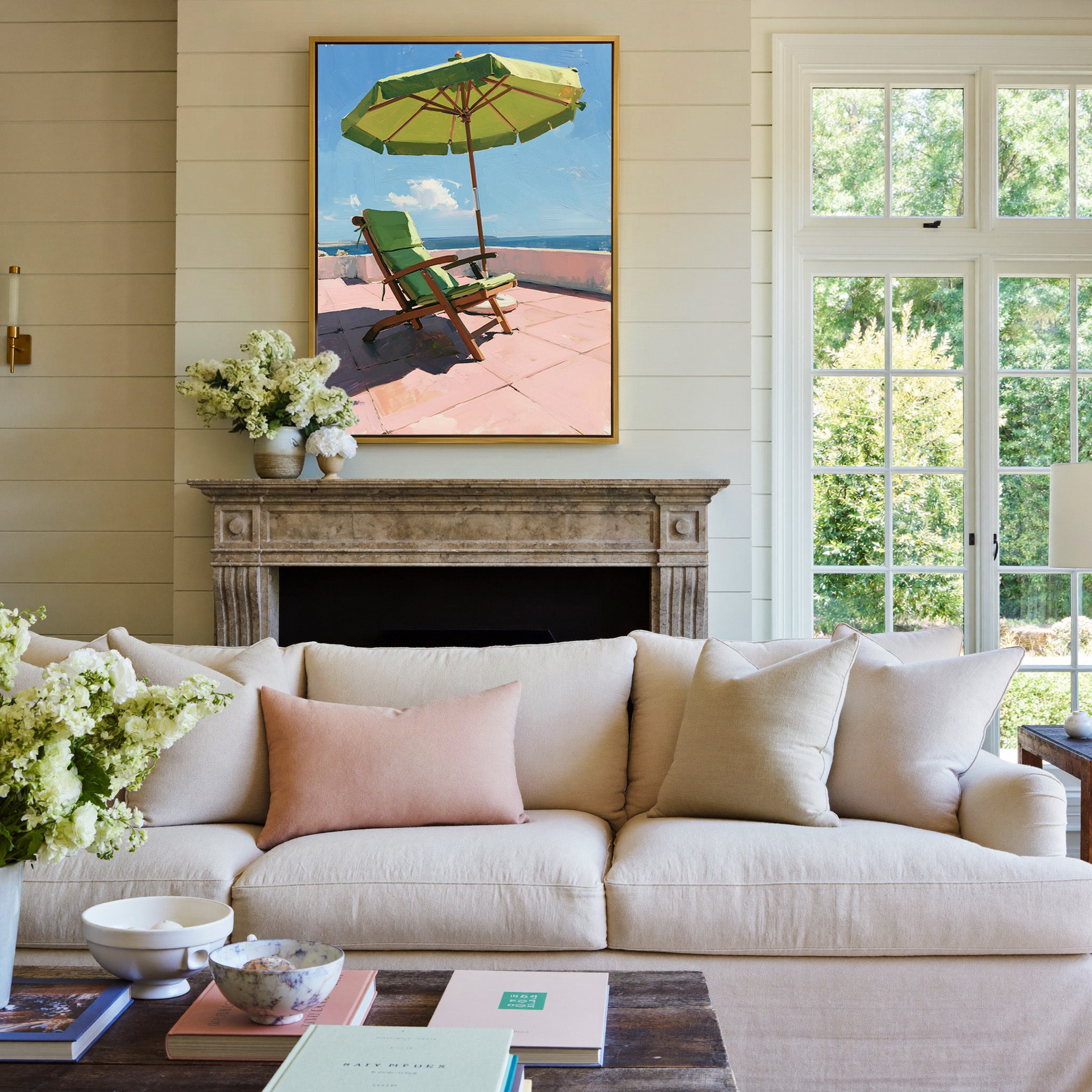 green umbrella and chair on a pink terrace canvas wall art in a gold frame above a mantel