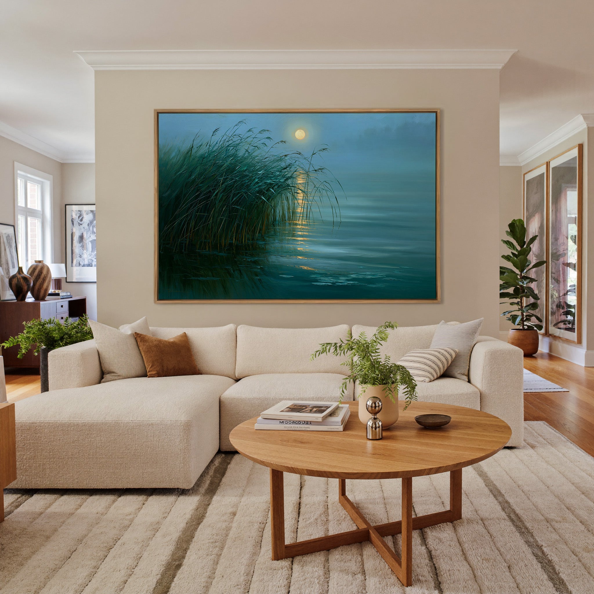 teal lake with reeds and gold moon reflection canvas wall art in an oak frame in a living room