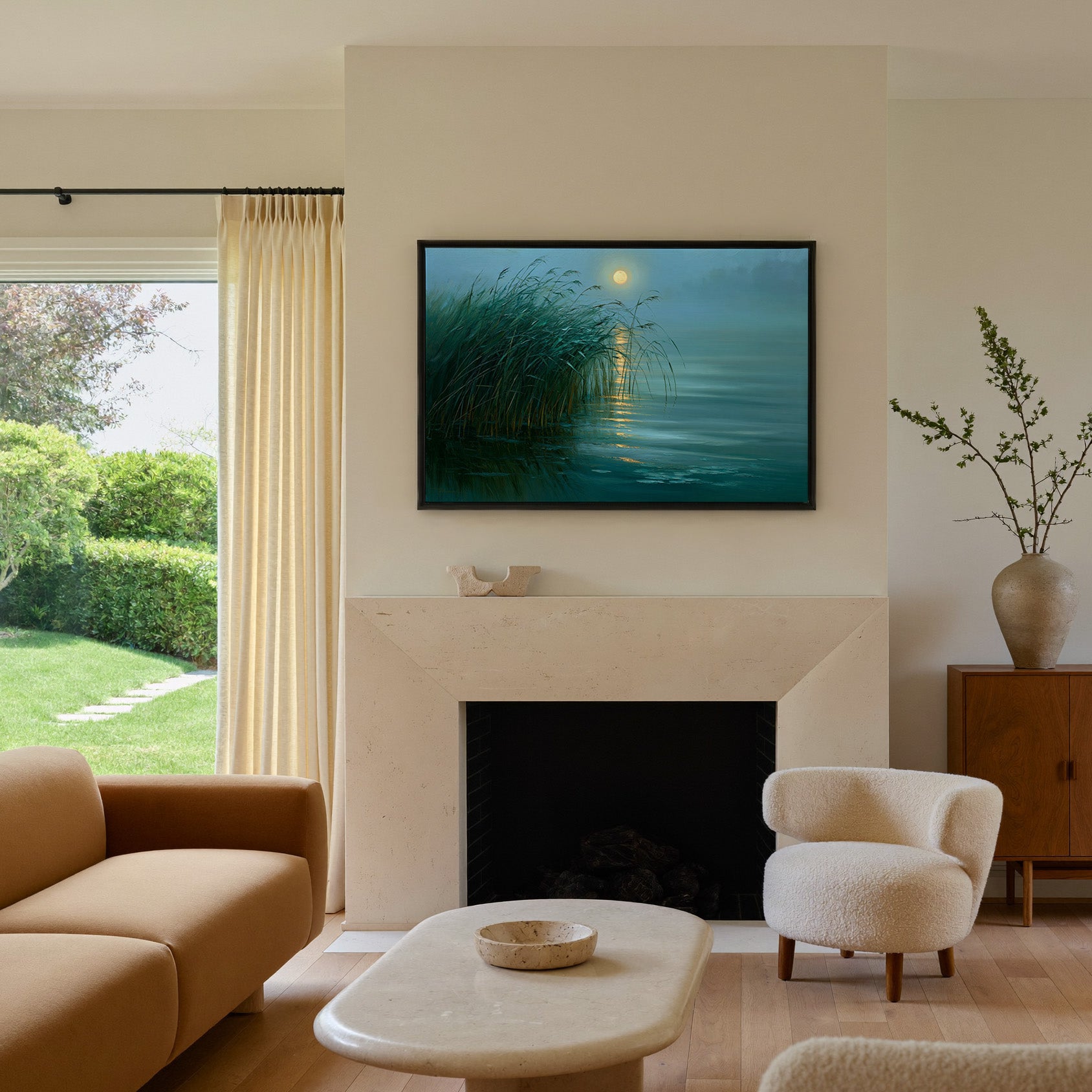 teal lake with reeds and gold moon reflection canvas wall art in a black frame above a mantel