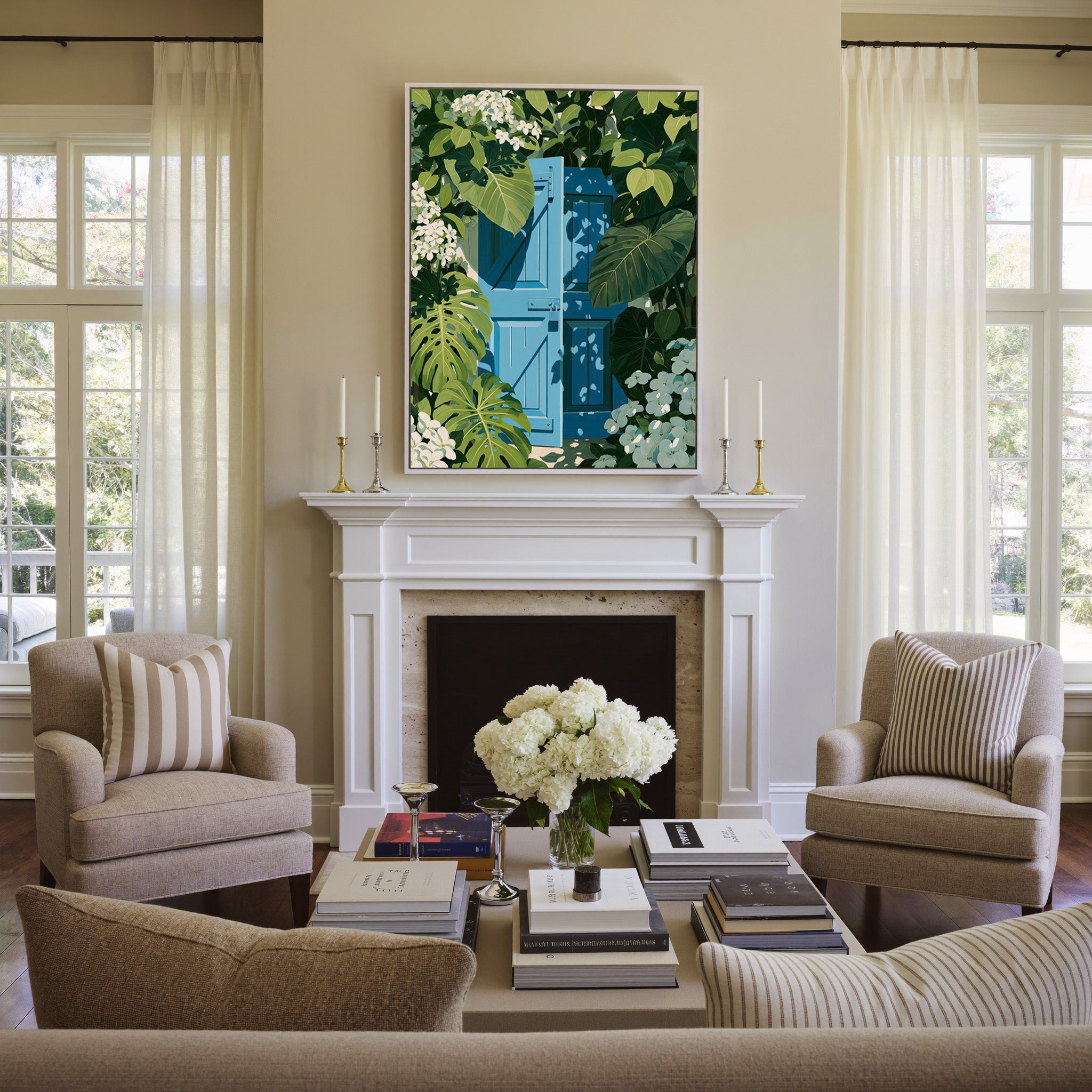 bright blue gate framed by oversized green canvas wall art in a white frame above a mantel
