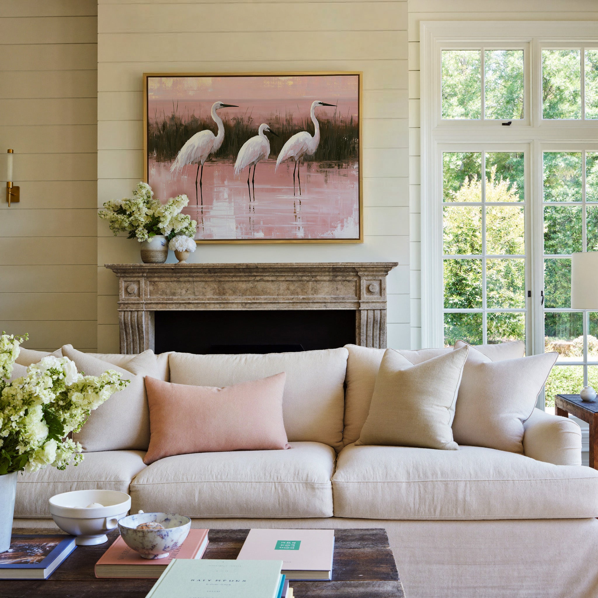 white egrets in shallow pink water canvas wall art in a gold frame above a mantel