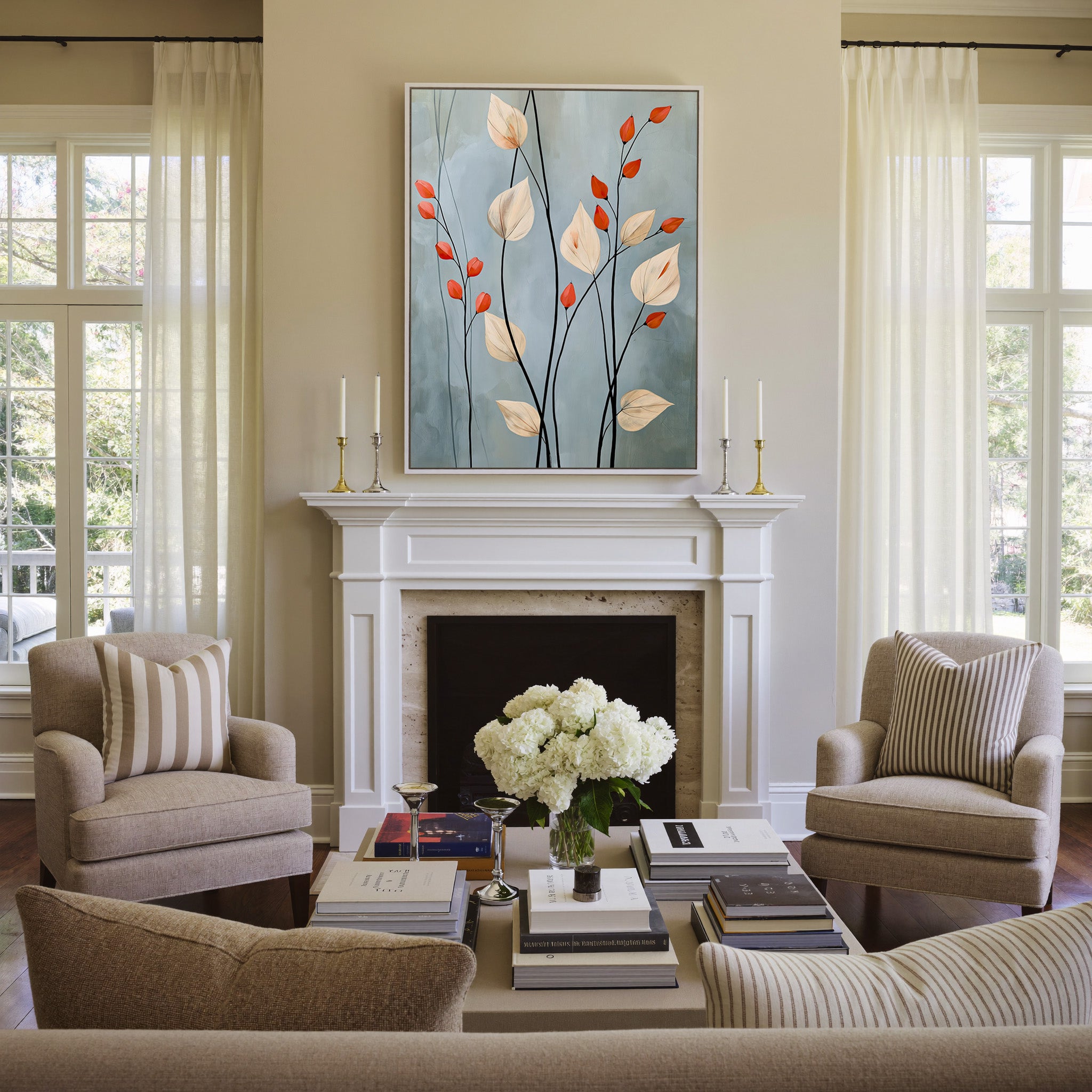 cream leaves and black stems on a blue gray canvas wall art in a white frame above a mantel