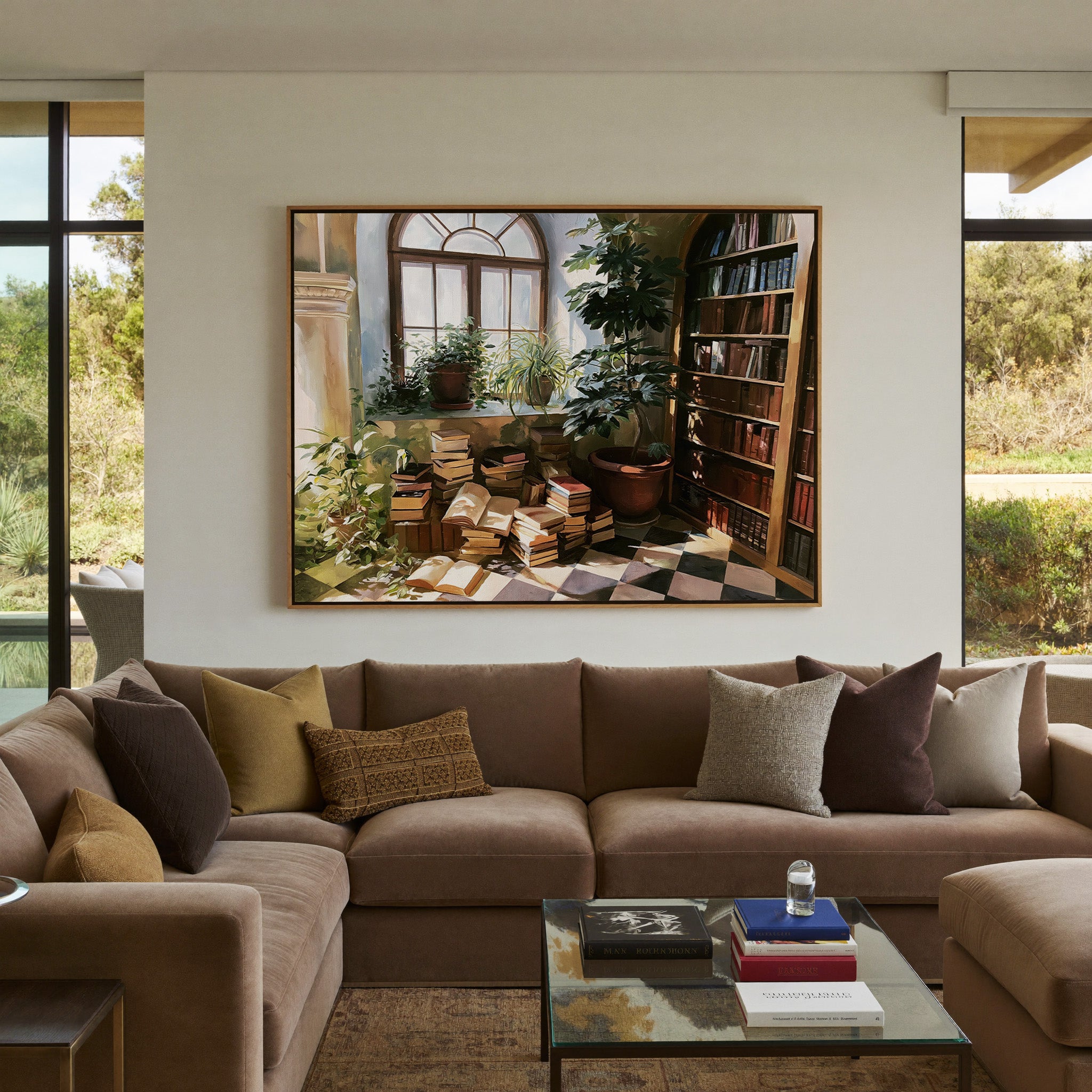 arched window with stacked books and potted canvas wall art in an oak frame in a styled room setting