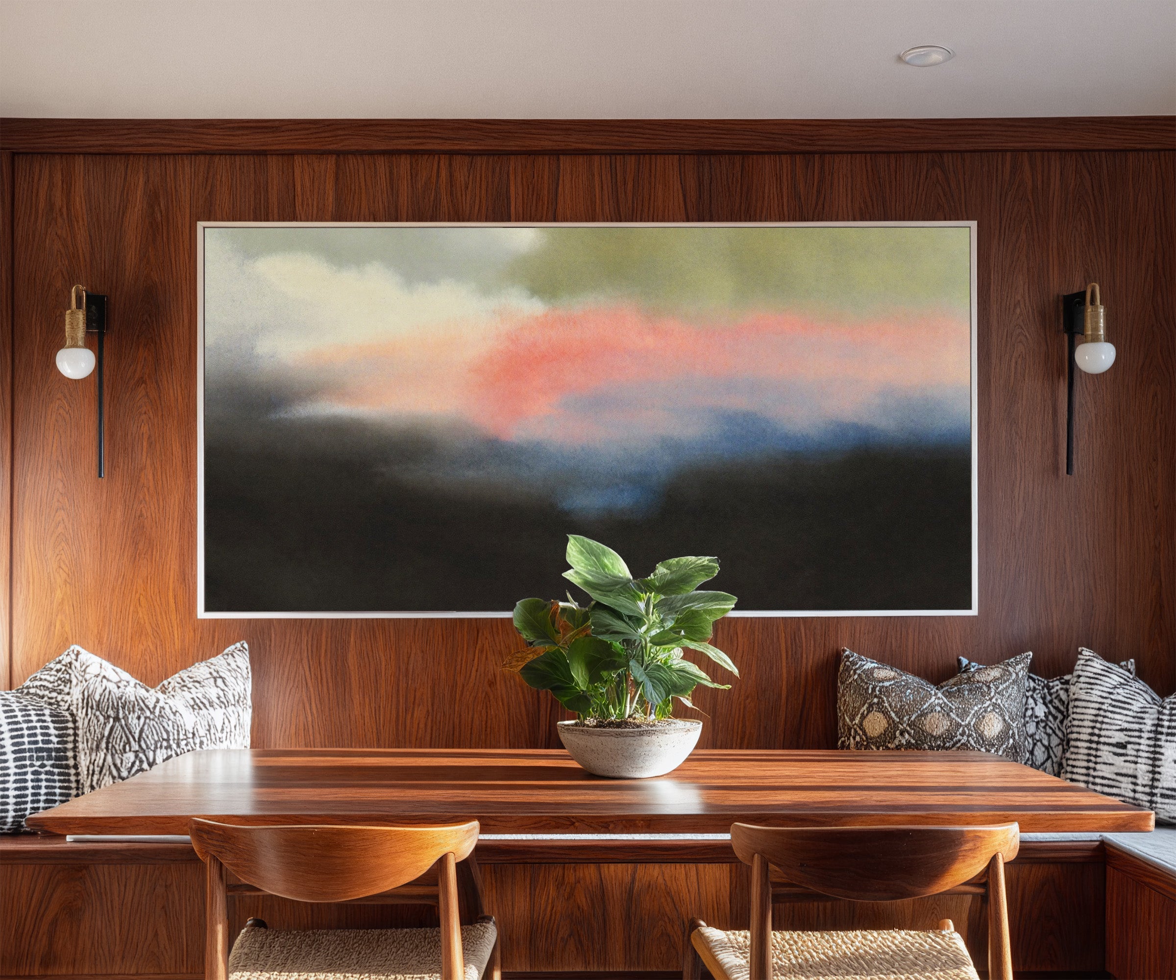 soft pink and blue abstract with dark grounding canvas wall art in a white frame in a styled room setting