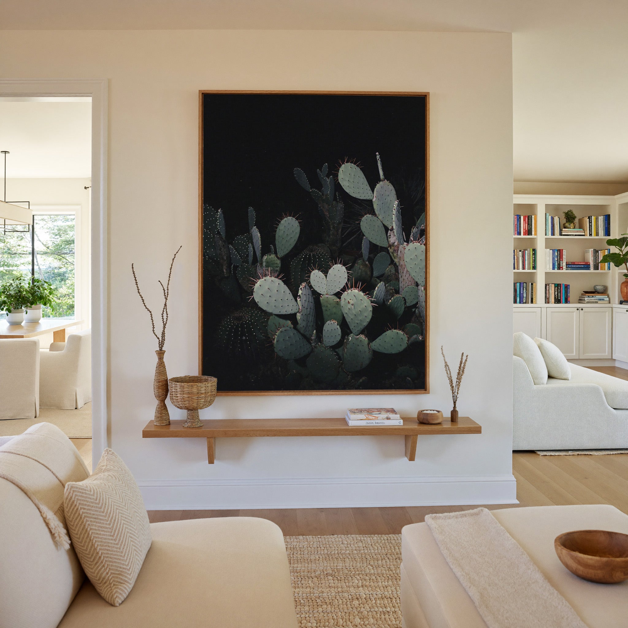 dark prickly pear cactus with pale pads canvas wall art in an oak frame in a living room