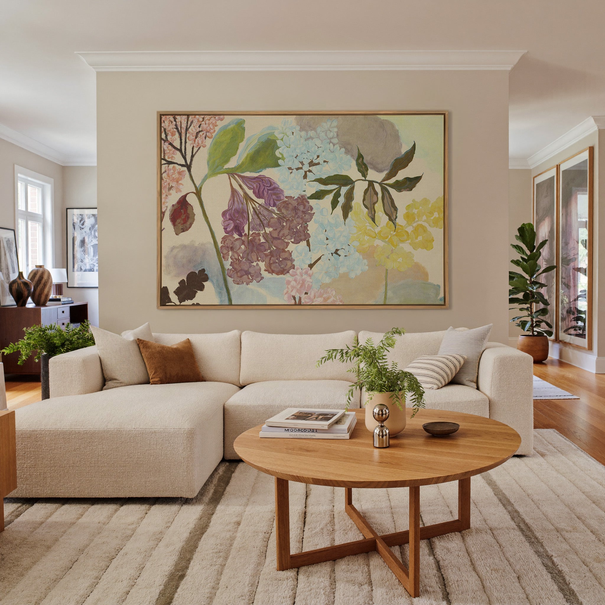 soft pastel floral branches with clustered canvas wall art in an oak frame in a living room