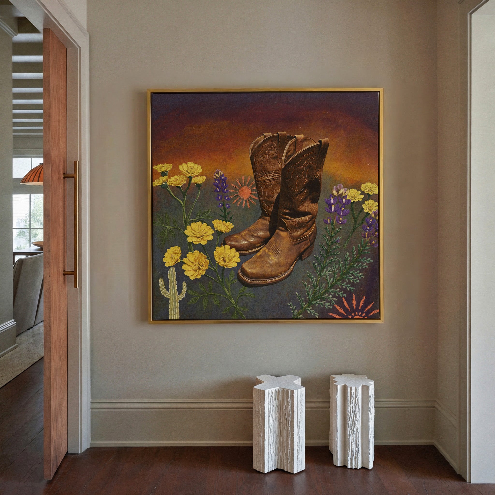 brown boots with yellow and purple wildflowers canvas wall art in a gold frame in a styled room setting