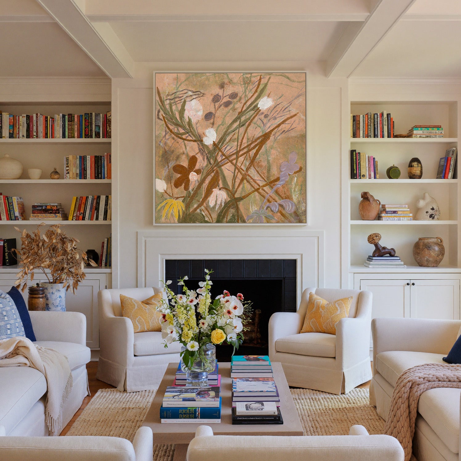 soft botanical meadow with warm tan ground and canvas wall art in a white frame above a fireplace