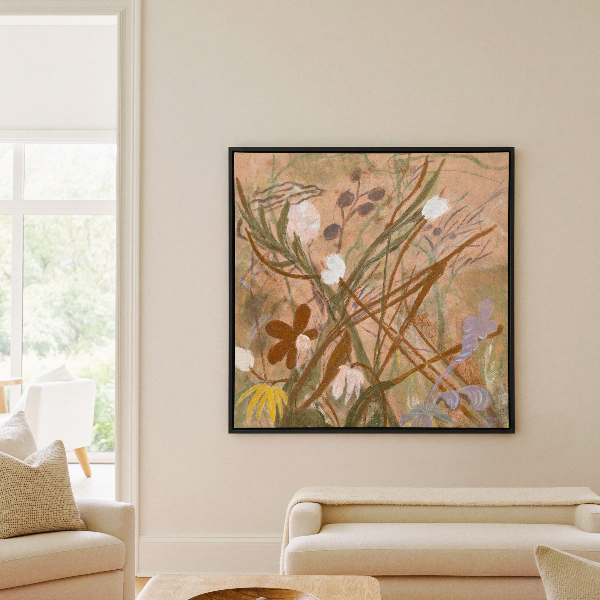 soft botanical meadow with warm tan ground and canvas wall art in a black frame in a living room