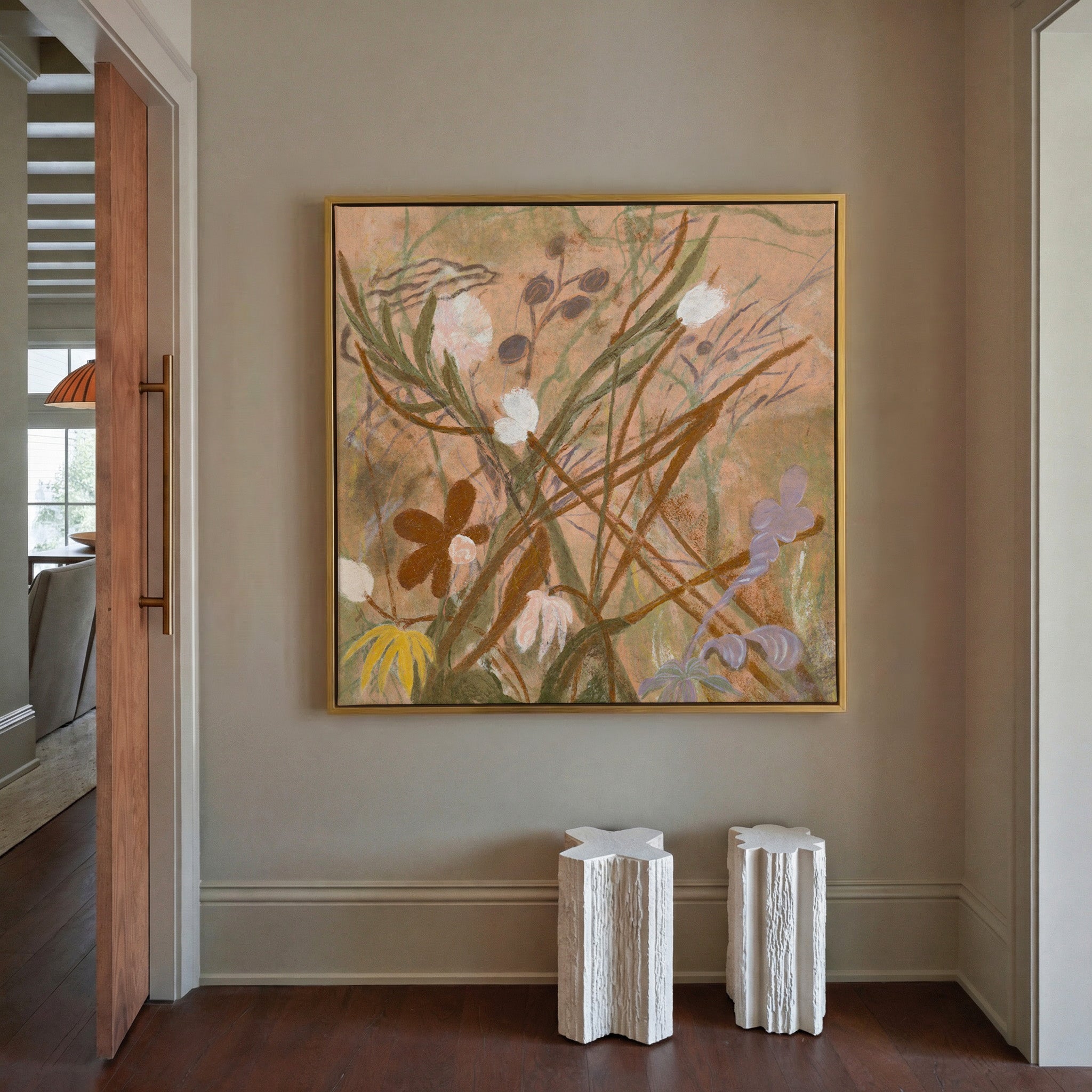 soft botanical meadow with warm tan ground and canvas wall art in a gold frame in a styled room setting