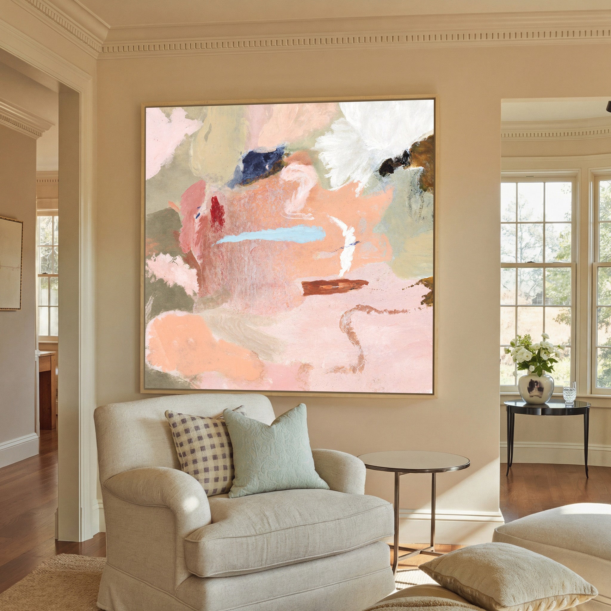 soft peach and blush abstract canvas wall art in a natural wood frame in a styled room setting