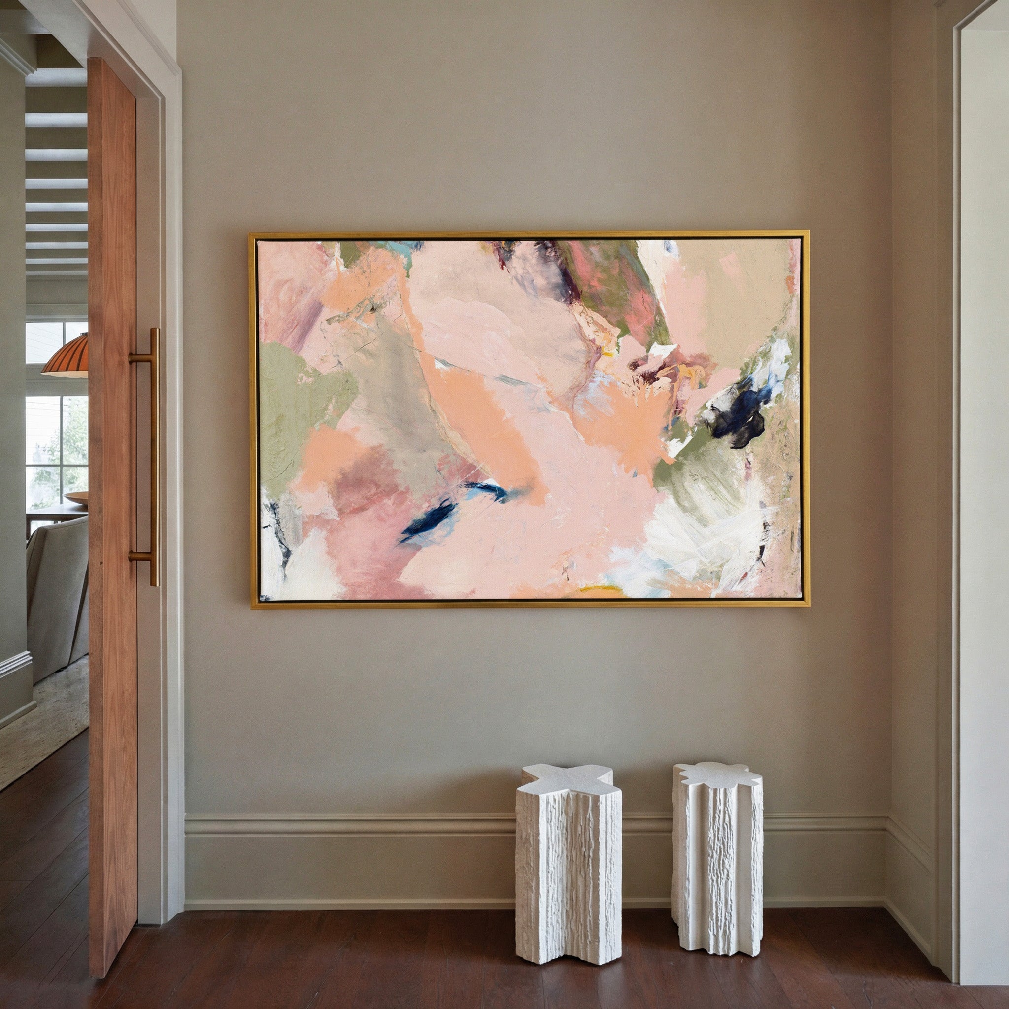 soft blush, peach, sage, and navy abstract canvas wall art in a gold frame in a styled room setting