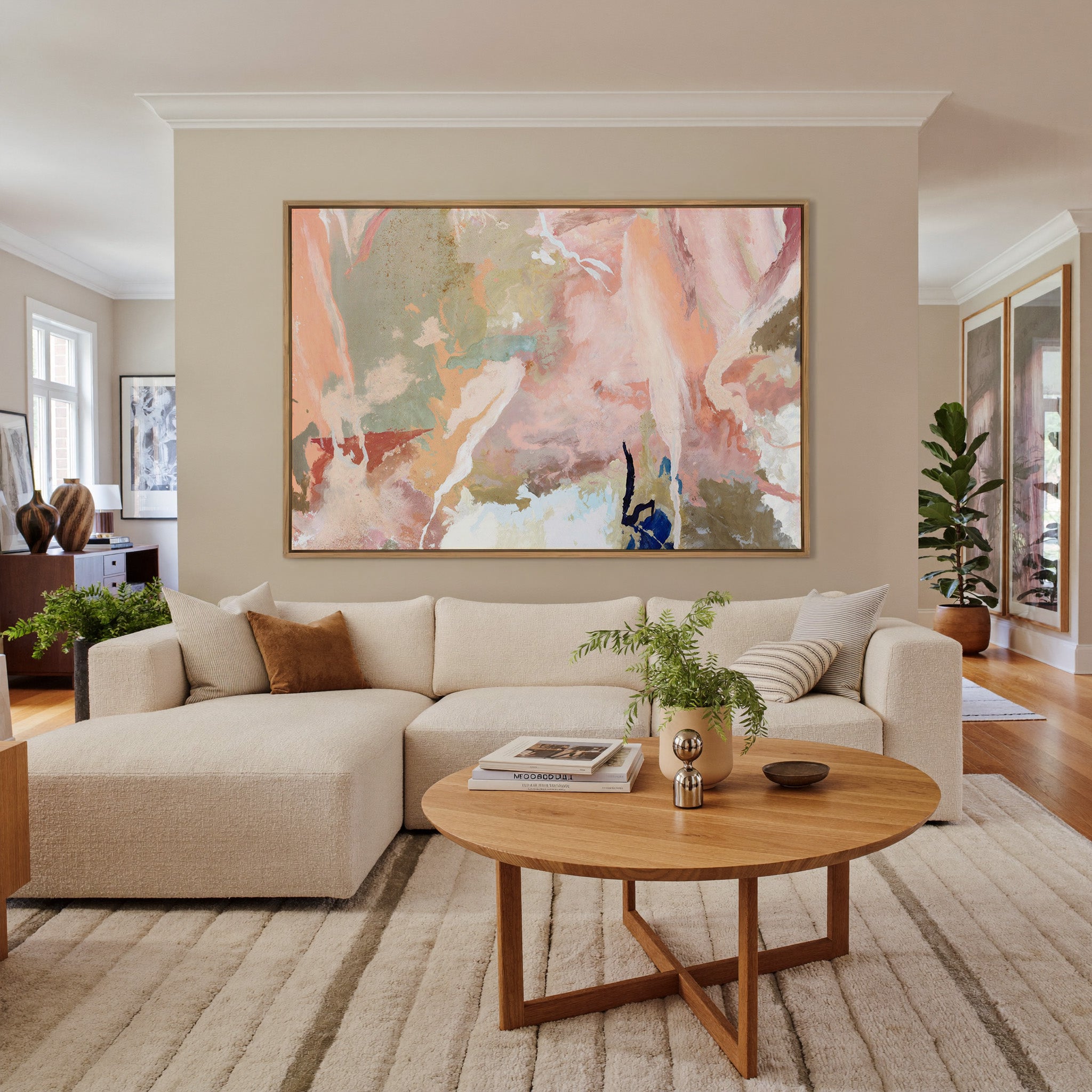 soft peach and sage abstract canvas wall art in an oak frame in a living room