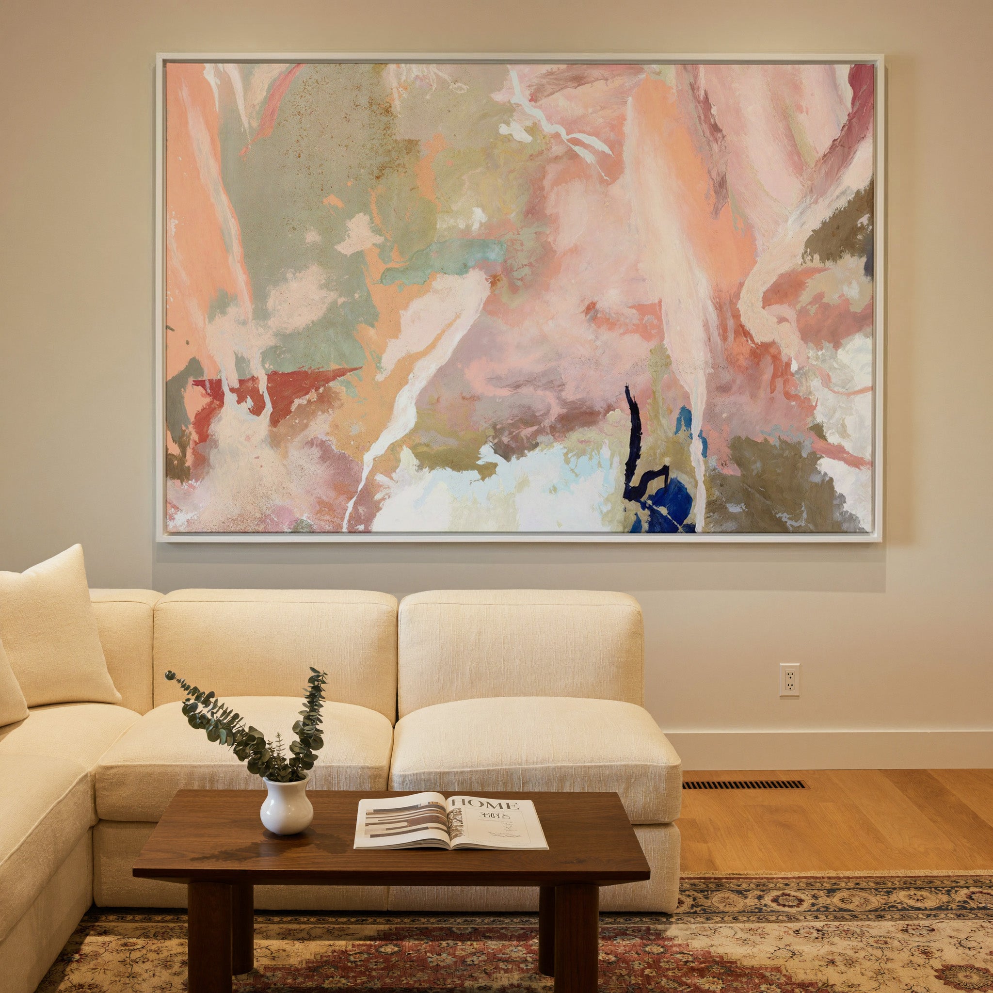 soft peach and sage abstract canvas wall art in a white frame in a styled room setting