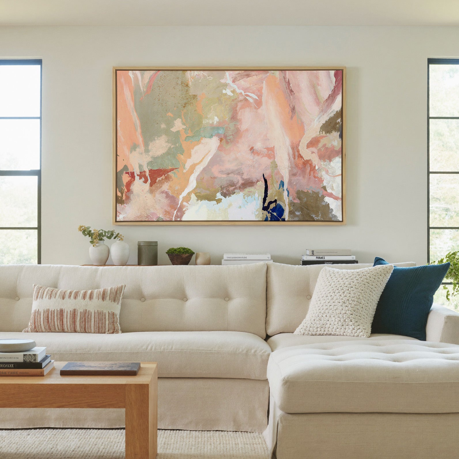 soft peach and sage abstract canvas wall art in a natural wood frame in a living room