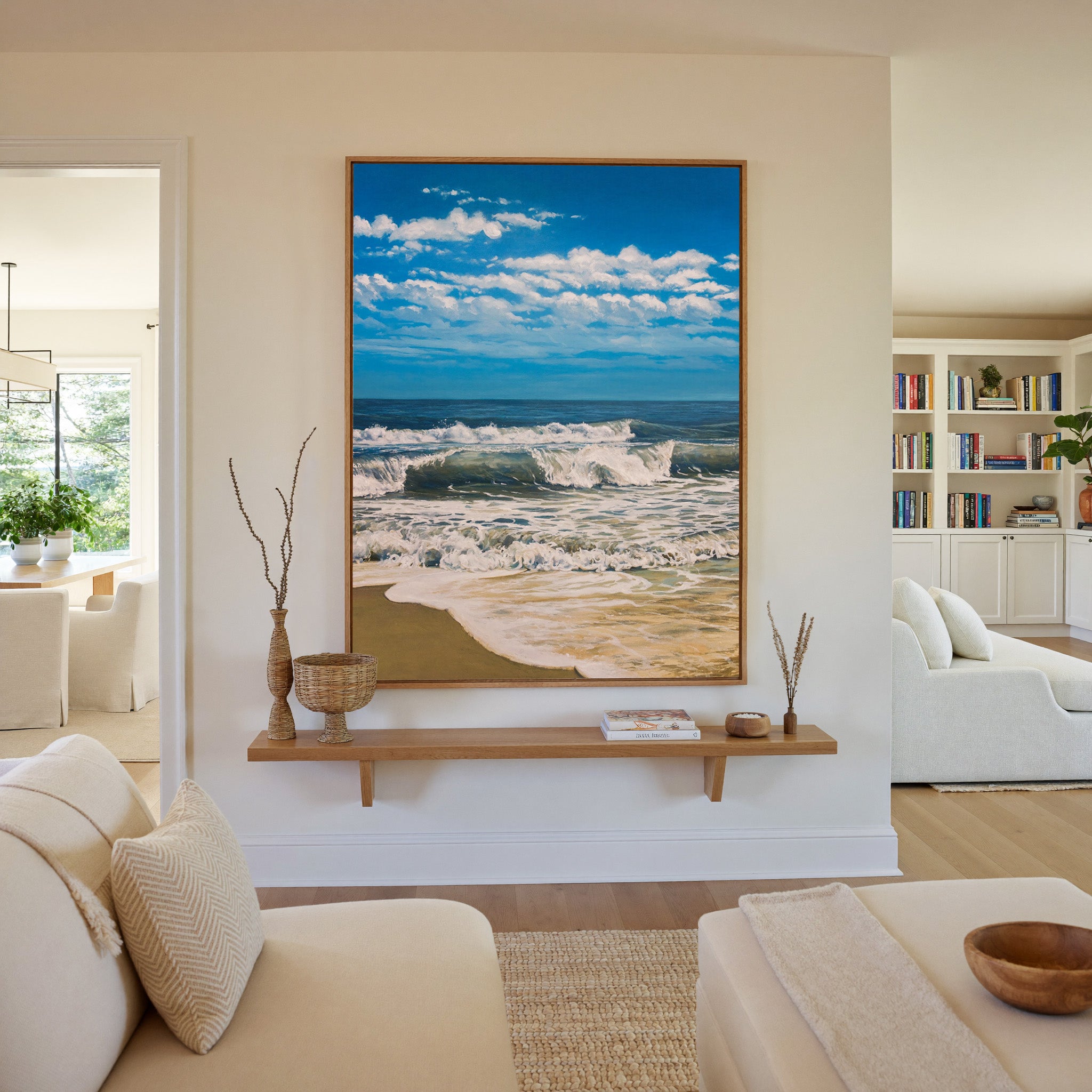bright blue seascape with foamy surf and a wide canvas wall art in an oak frame in a living room