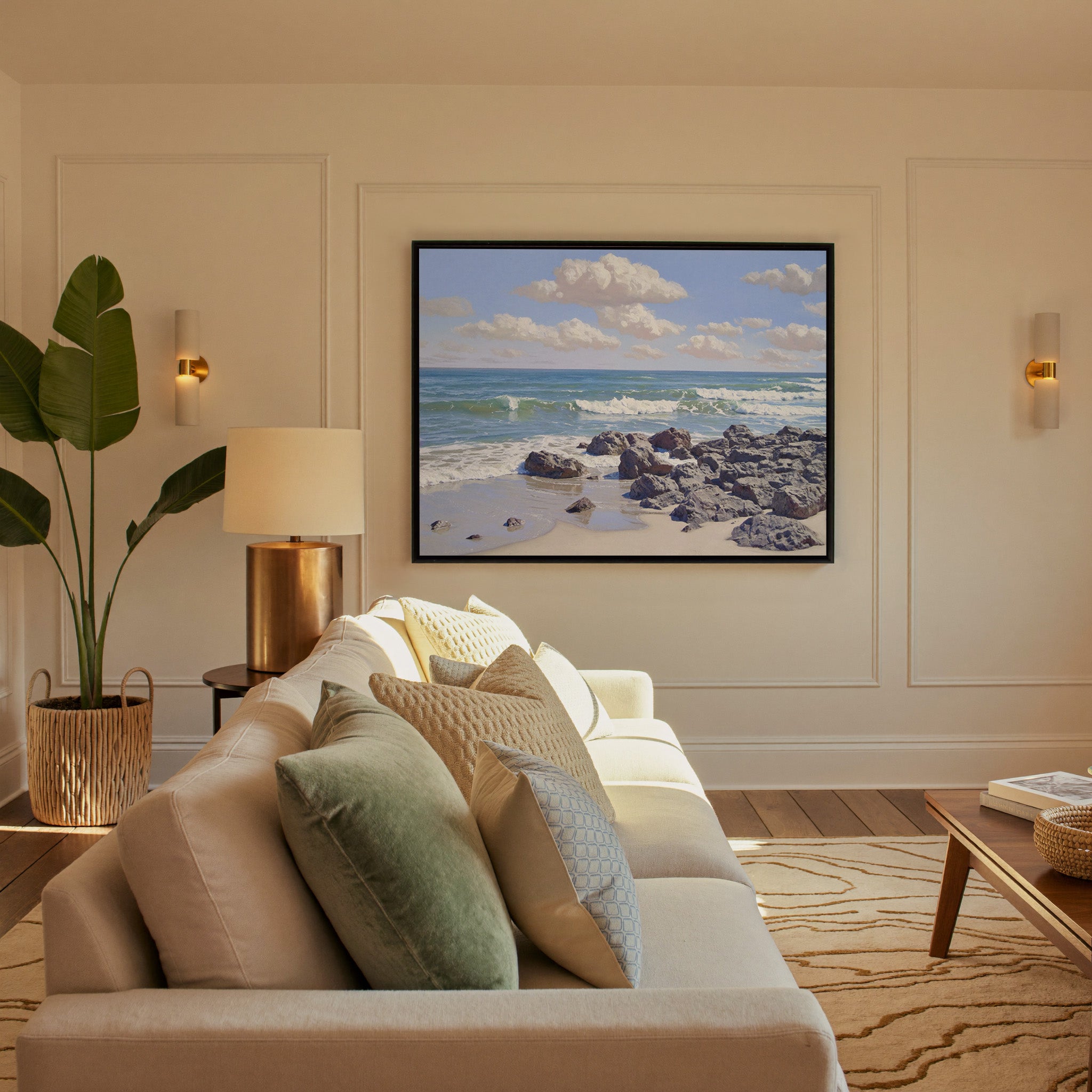 rocky shore with rolling surf and soft cloud canvas wall art in a black frame in a styled room setting