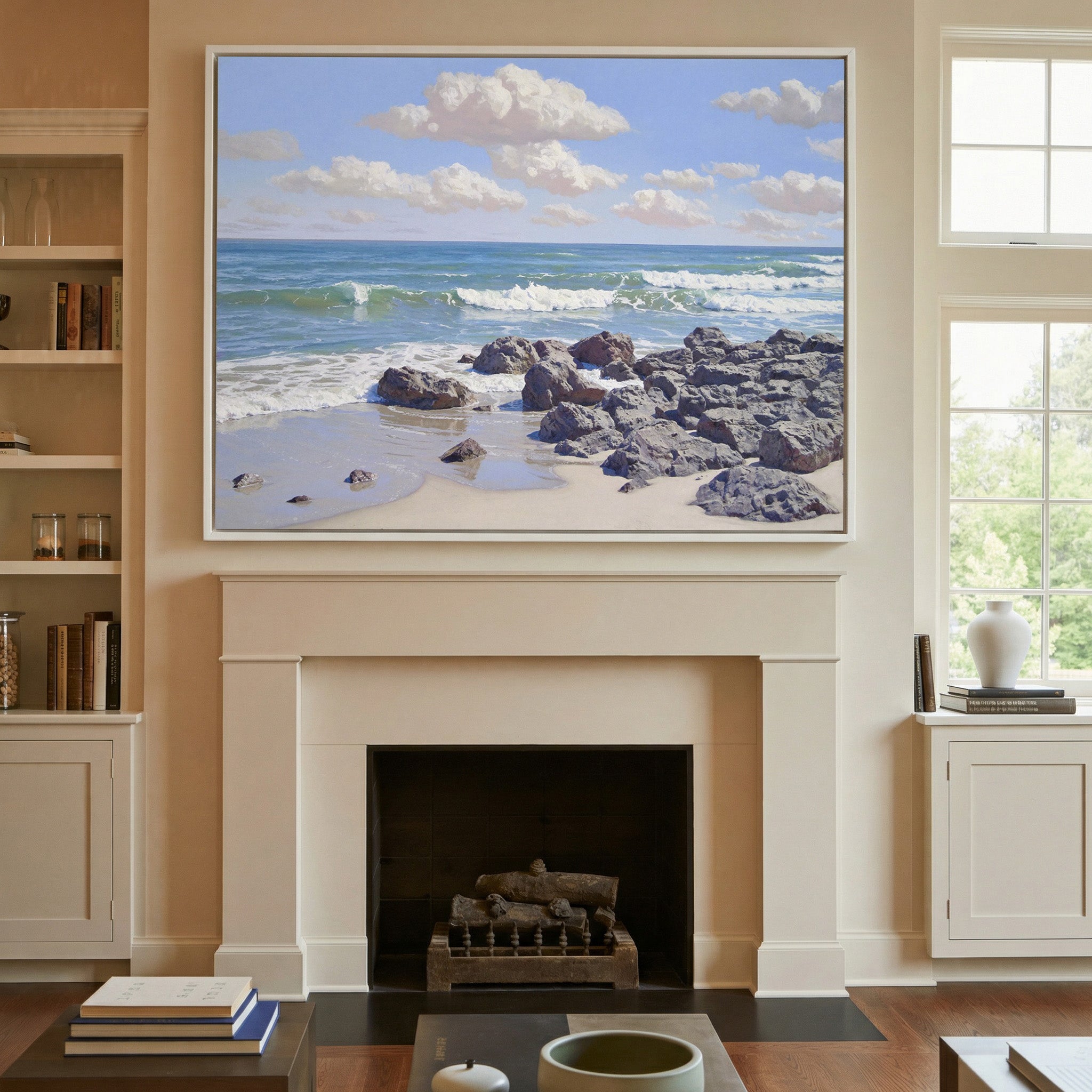 rocky shore with rolling surf and soft cloud canvas wall art in a white frame above a mantel