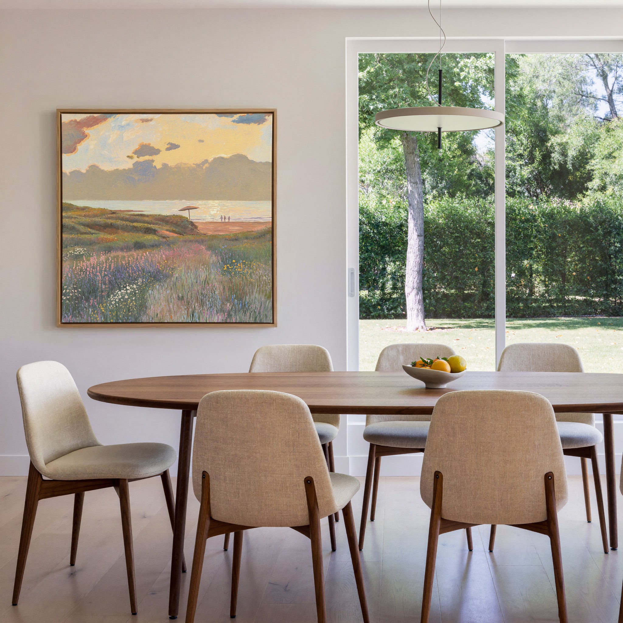 soft coastal meadow with pastel wildflowers and canvas wall art in an oak frame in a dining room