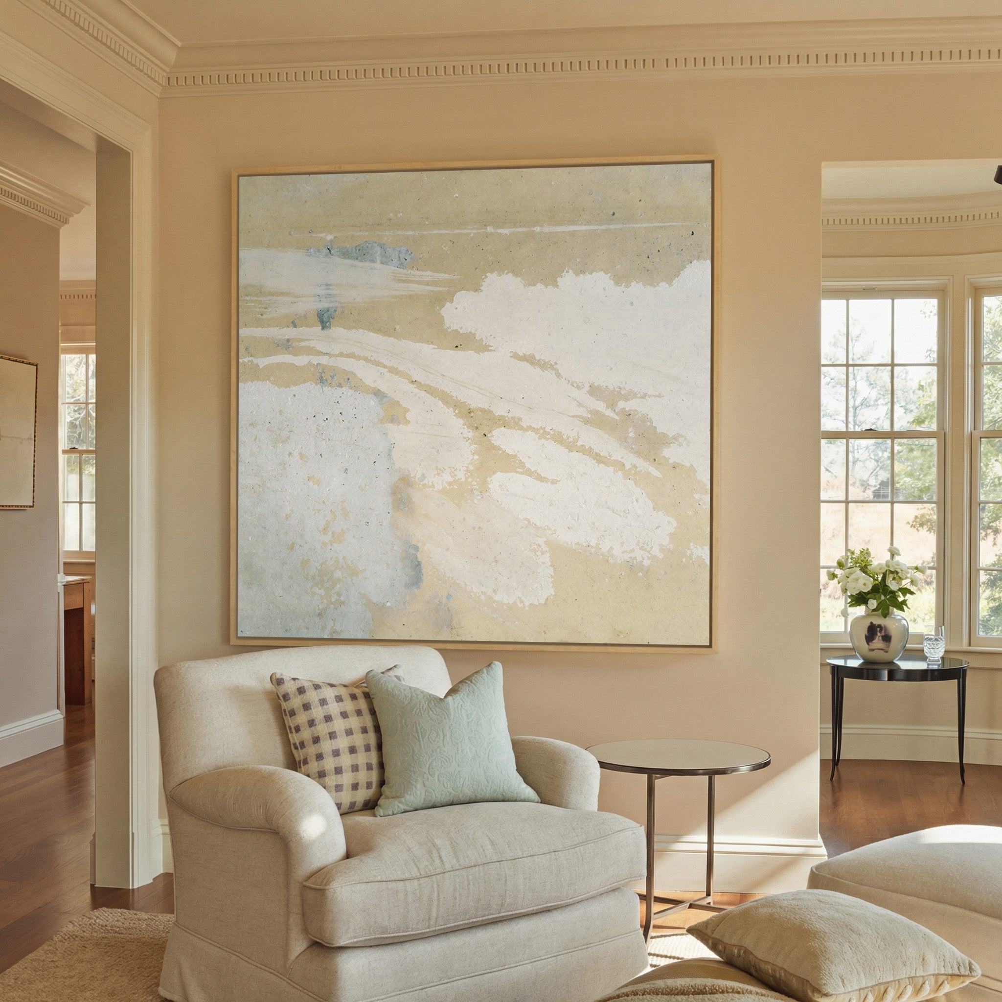 cream and sand abstract with pale canvas wall art in a natural wood frame in a styled room setting
