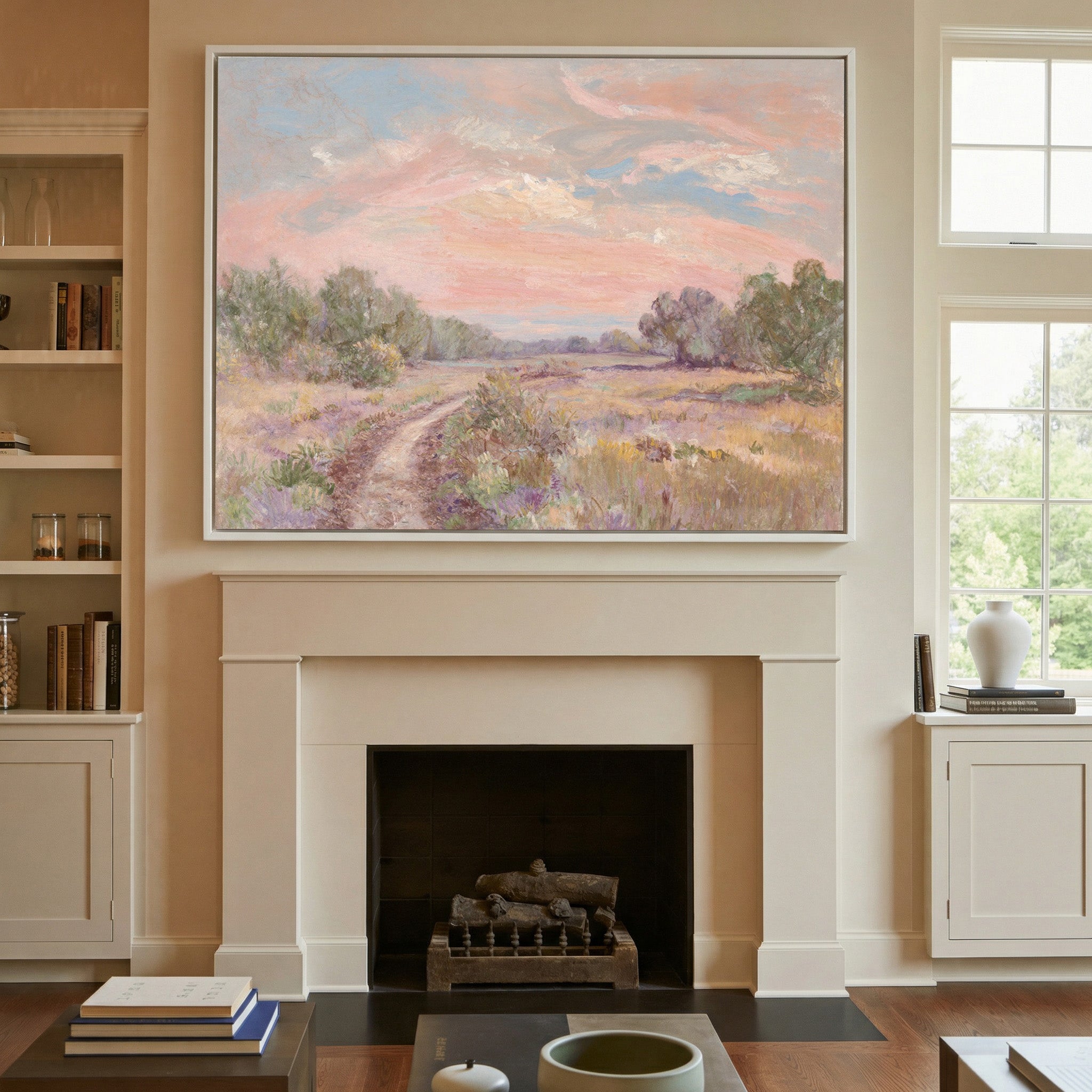 soft pink sky over a winding meadow path canvas wall art in a white frame above a mantel