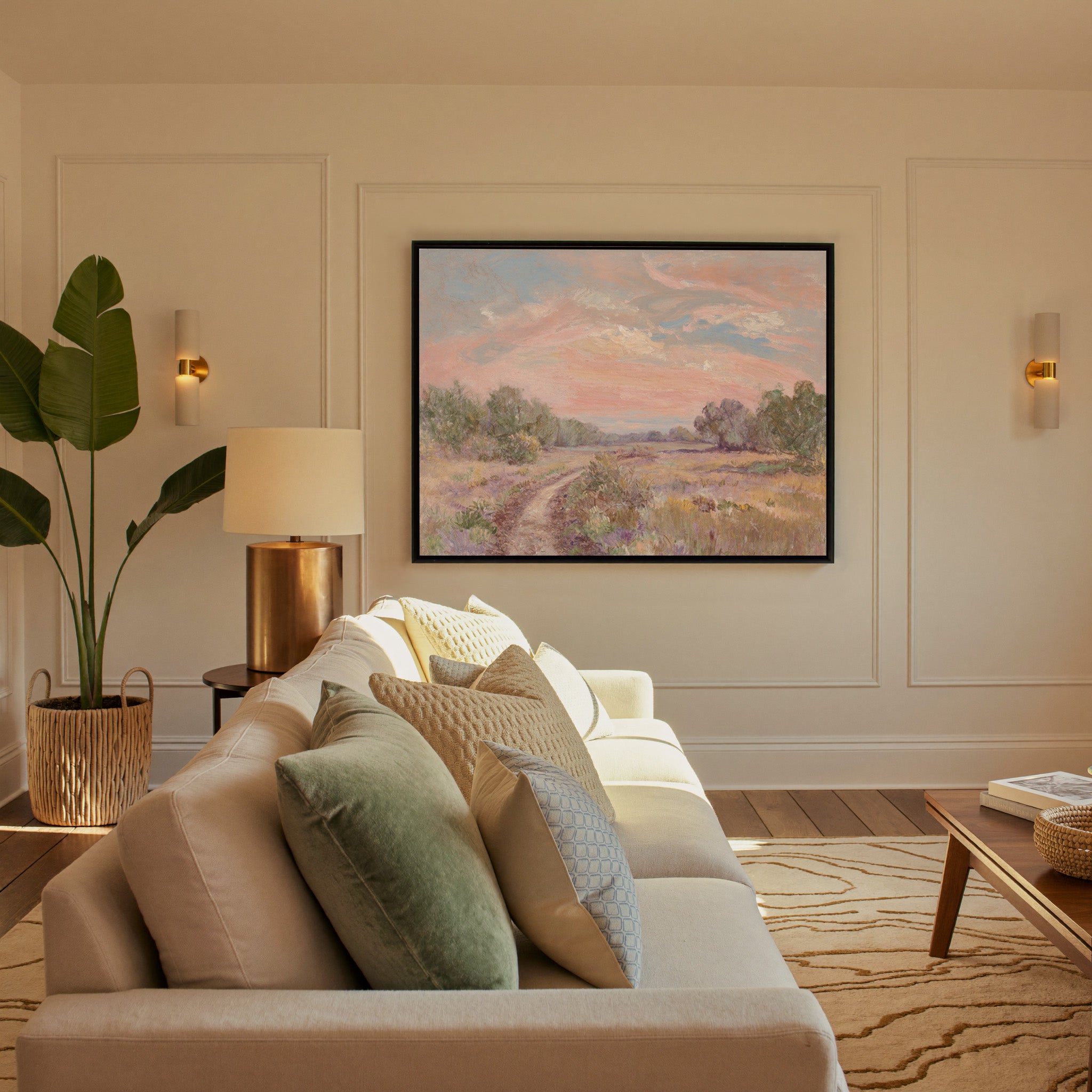 soft pink sky over a winding meadow path canvas wall art in a black frame in a styled room setting