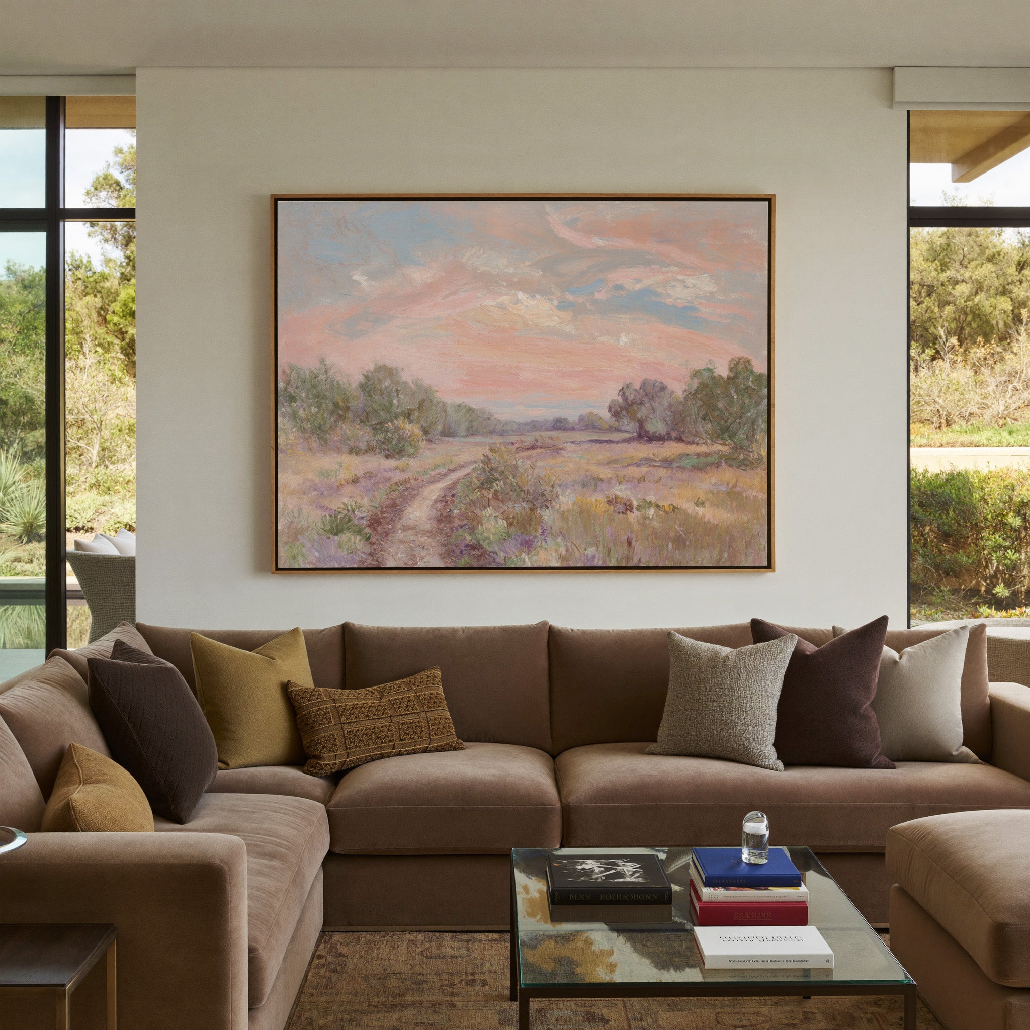 soft pink sky over a winding meadow path canvas wall art in an oak frame in a styled room setting