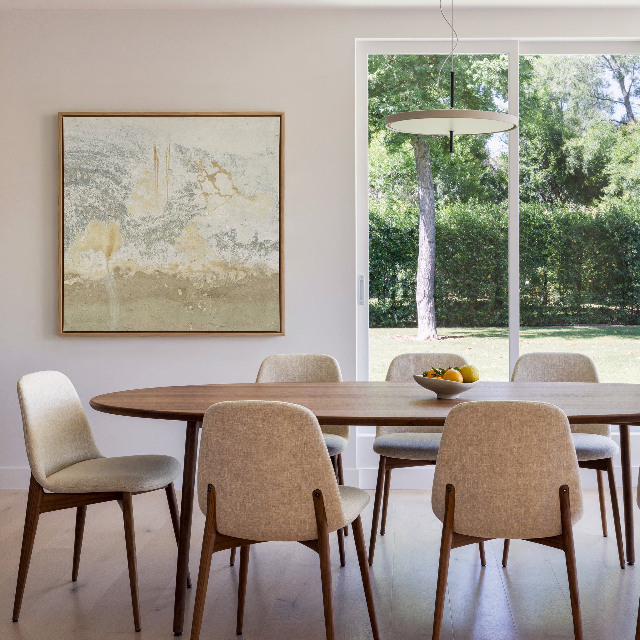 soft cream and taupe abstract with gray canvas wall art in an oak frame in a dining room