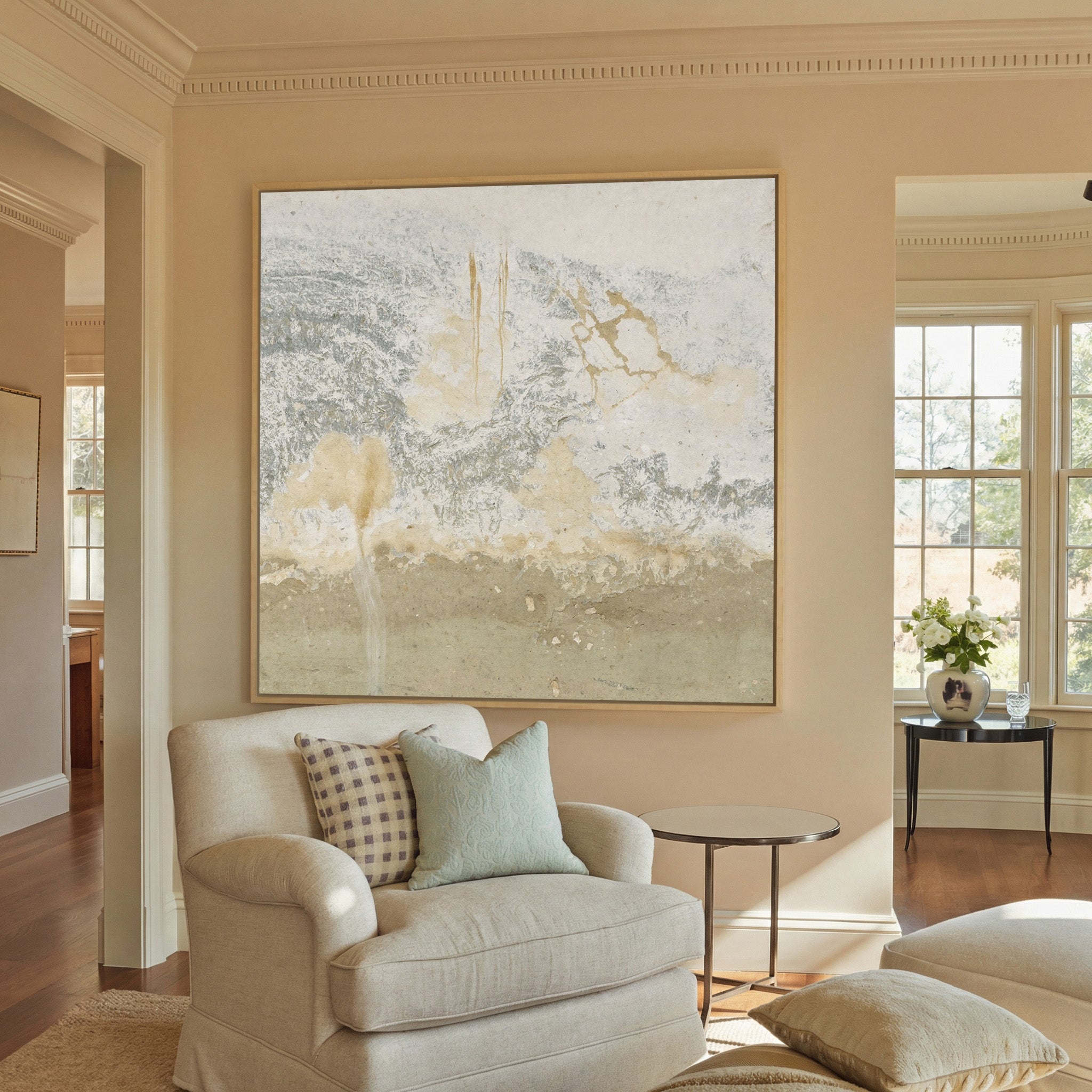 soft cream and taupe abstract with gray canvas wall art in a natural wood frame in a styled room setting