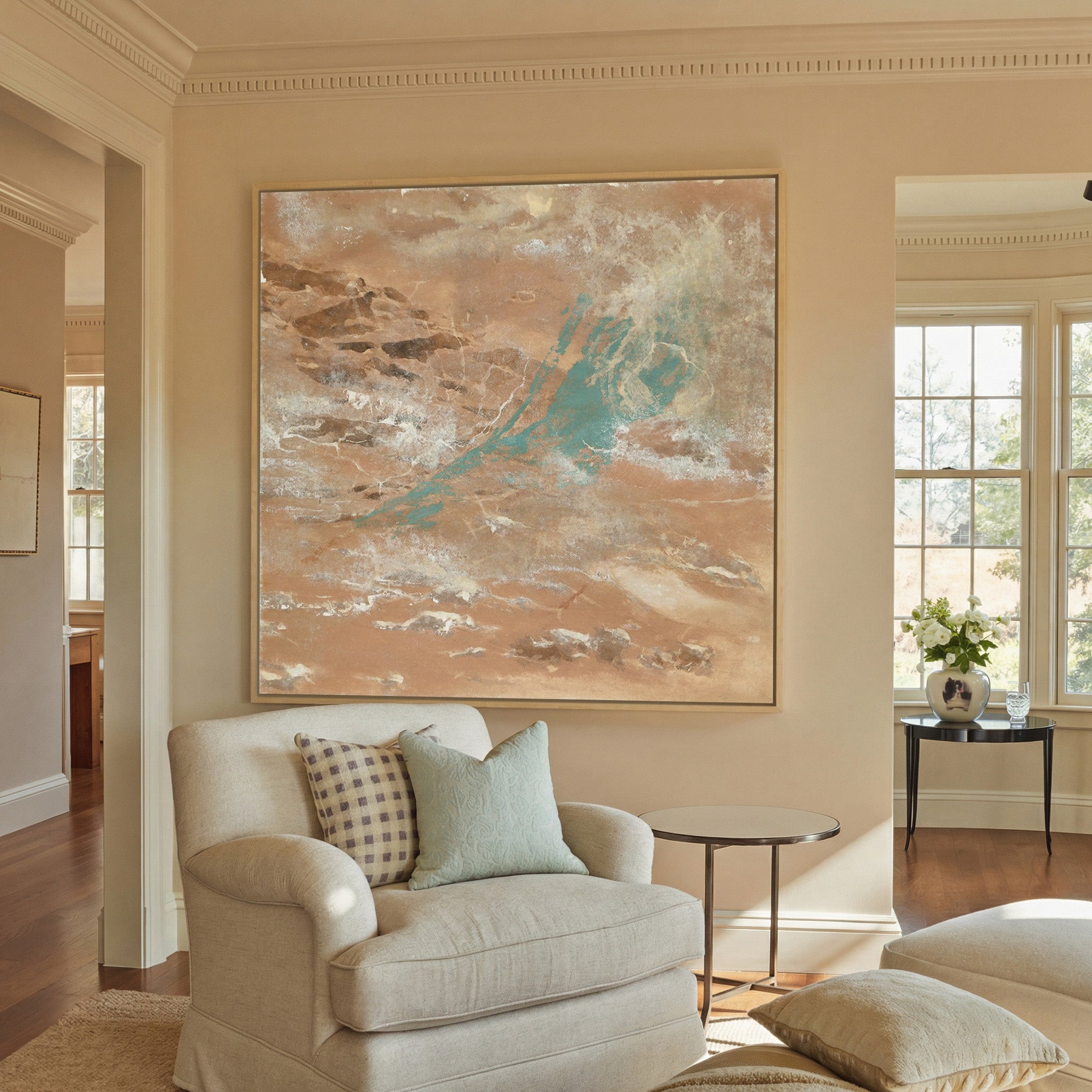 warm tan abstract with turquoise streaks and canvas wall art in a natural wood frame in a styled room setting