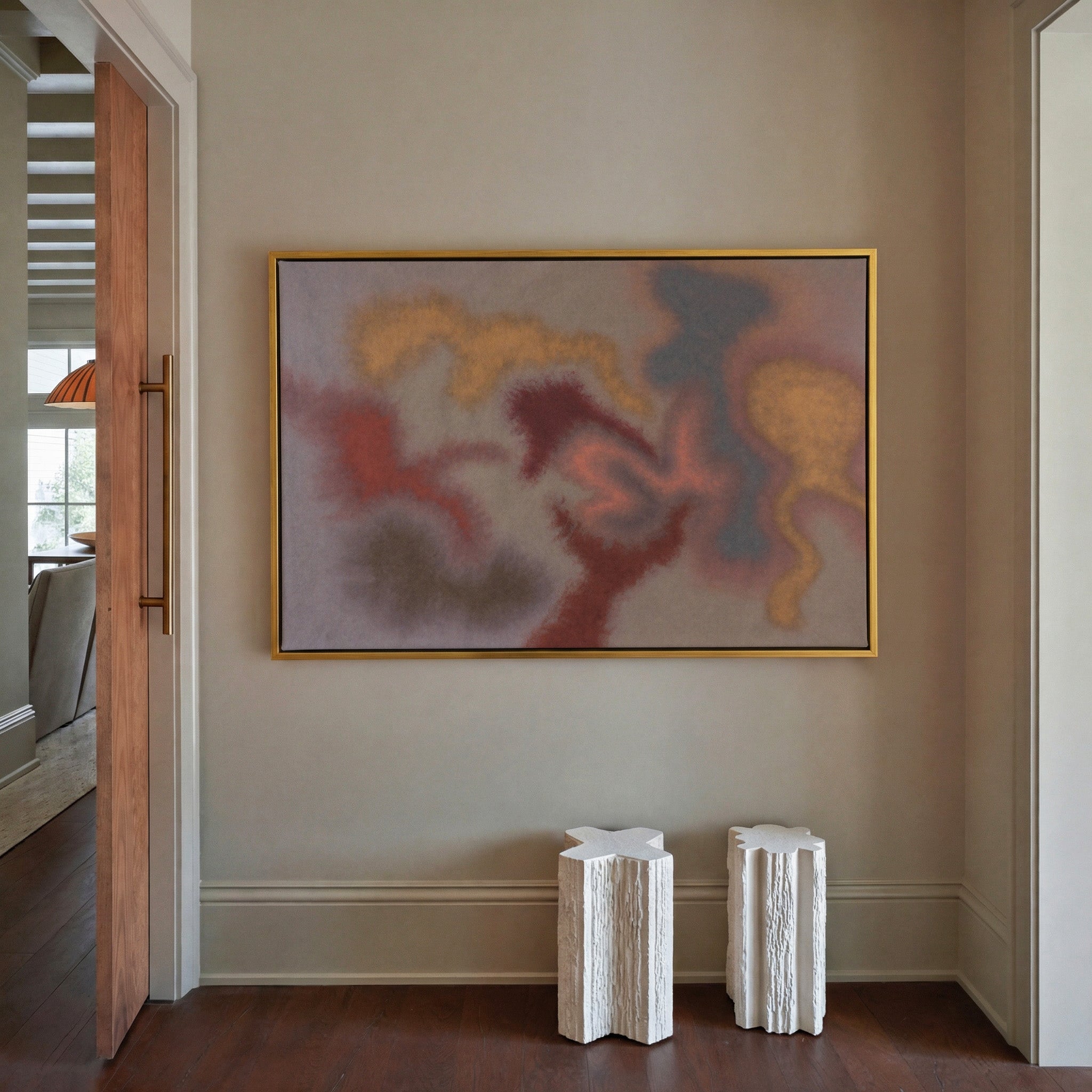 soft rust, gold, and slate abstract canvas wall art in a gold frame in a styled room setting