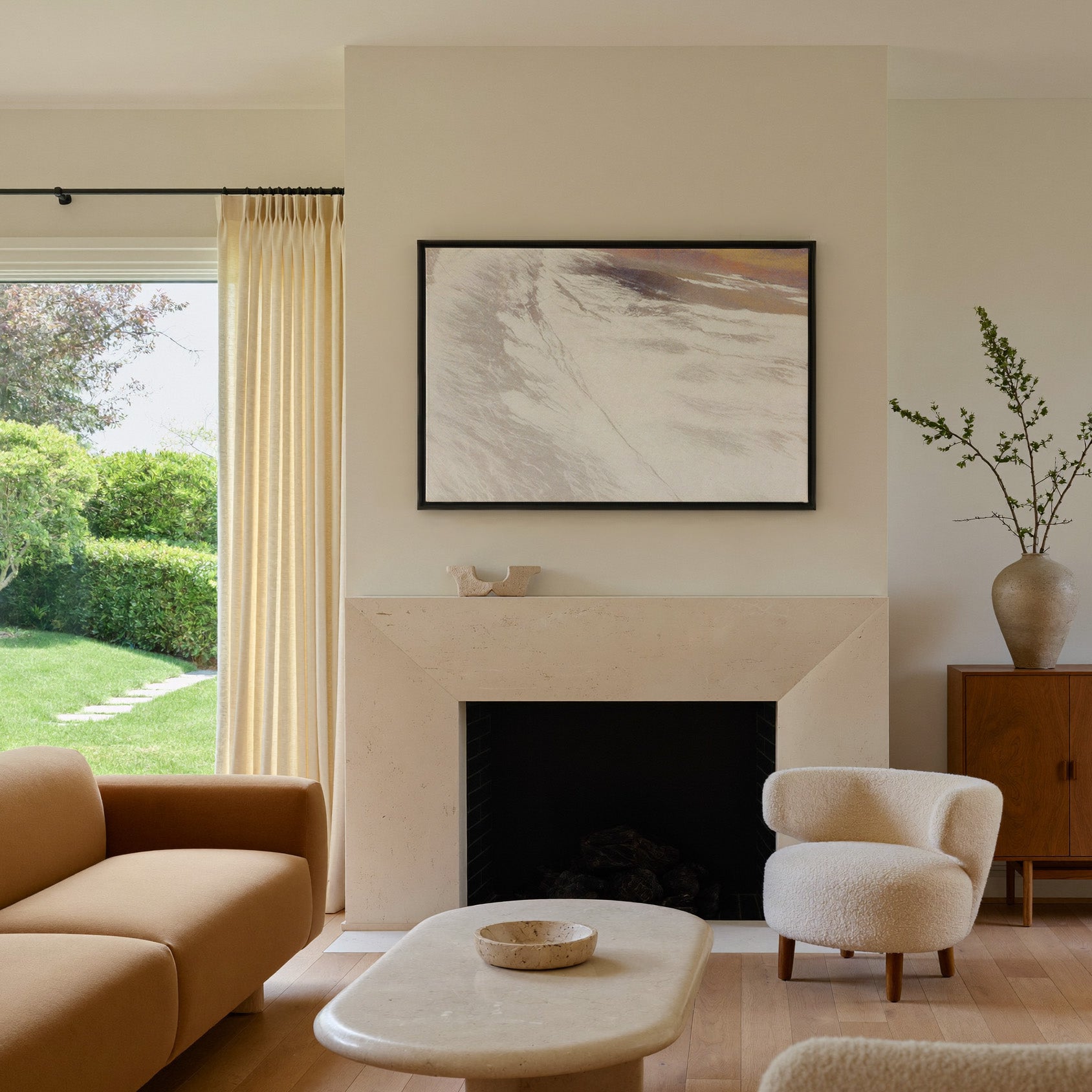 warm beige abstract with sweeping diagonal canvas wall art in a black frame above a mantel