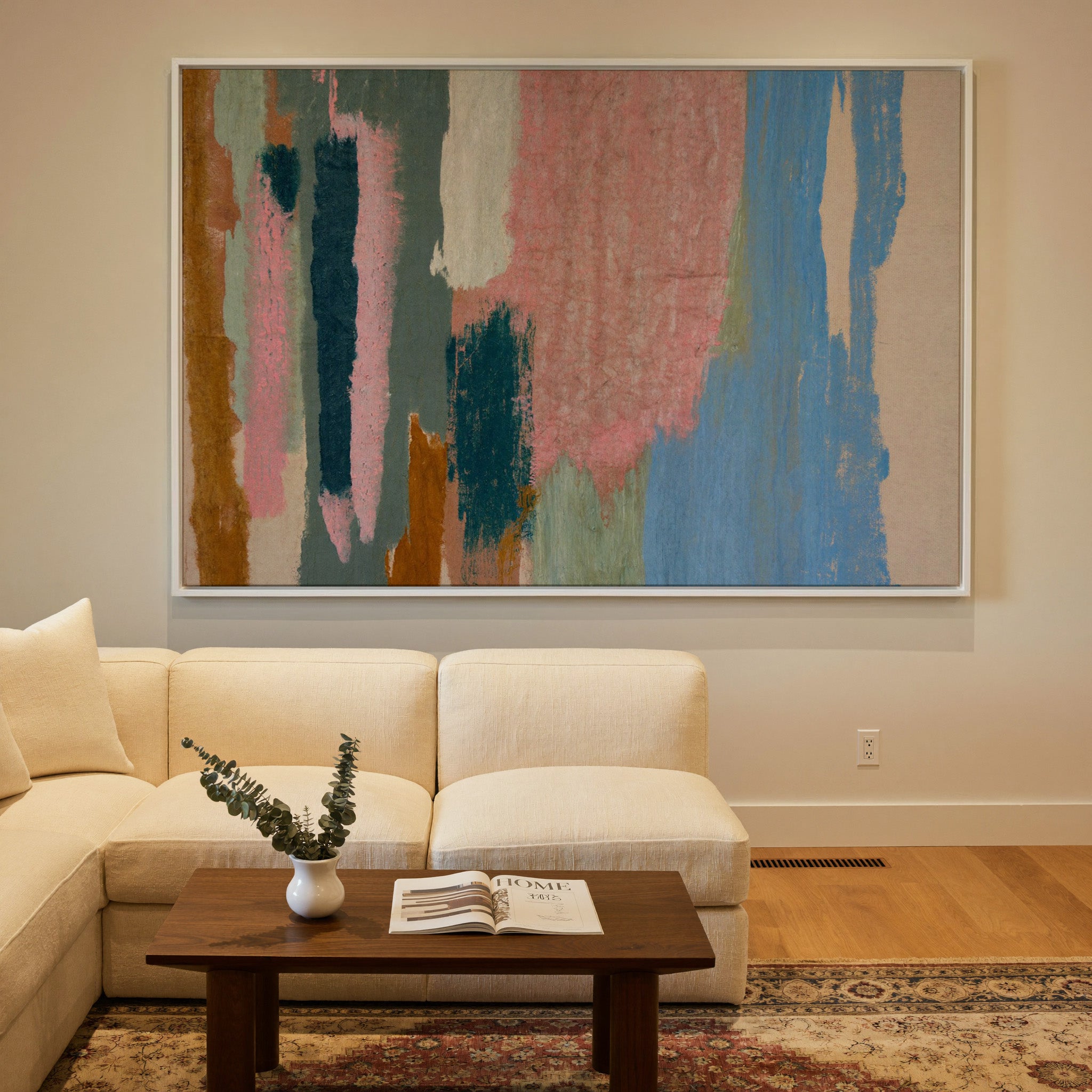 vertical abstract with pink, blue, teal, and canvas wall art in a white frame in a styled room setting