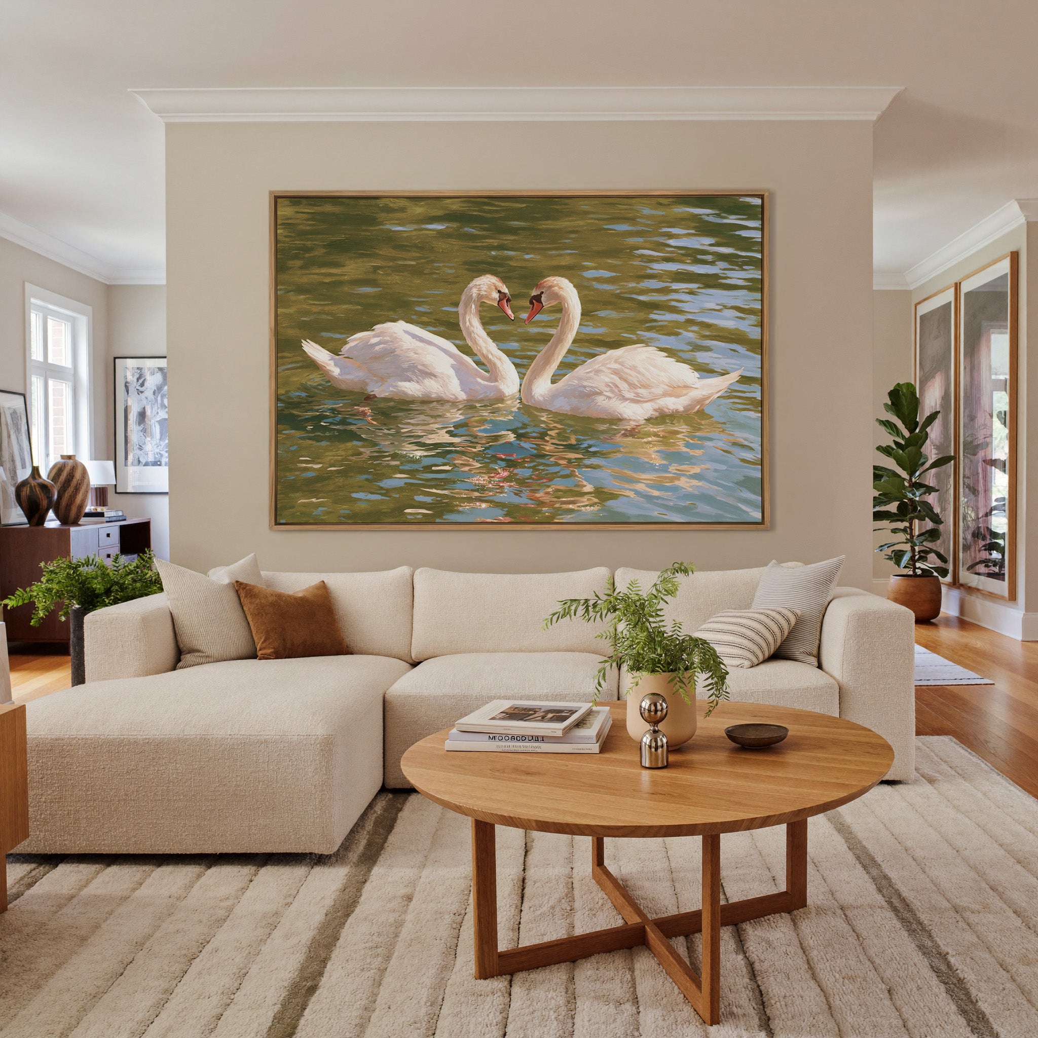 two white swans facing each other on green water canvas wall art in an oak frame in a living room